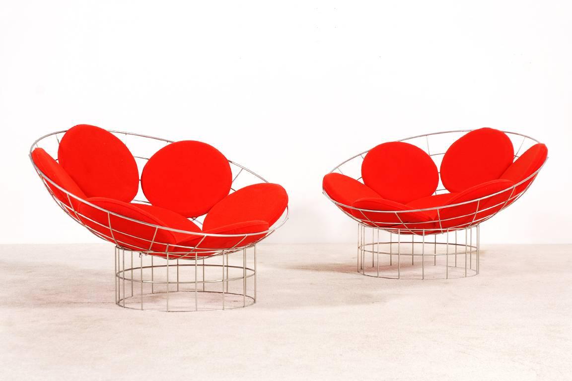 Pair of Peacock chairs designed by Verner Panton for Plus-Linje, circa 1959.

The Peacock chair is made up of two parts, assembled with cable clips. The structure has bowl shaped top and a cylindrical base galvanised stainless steel. The seat has