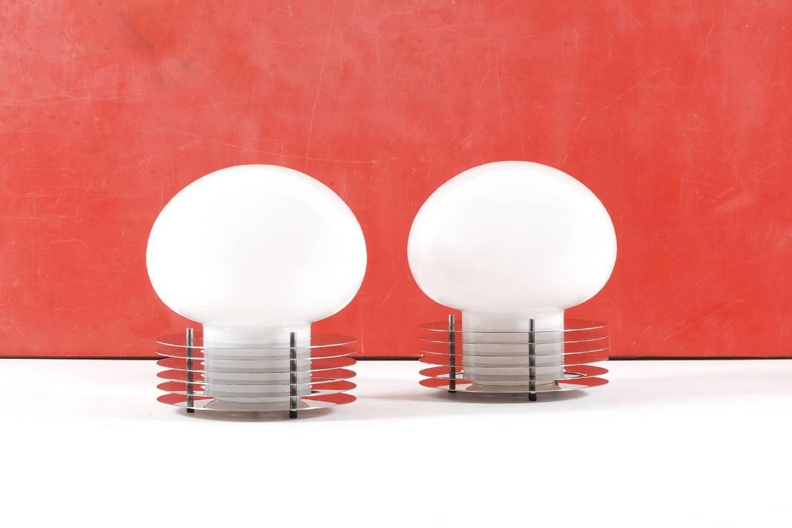 Pair of table lamps manufactured by Enrico Tronconi during the 1960s in Italy. 

Each lamp is made of a white opaline sphere and a base with several polished steel circles. 
Excellent condition.

Documentation pictures are available upon