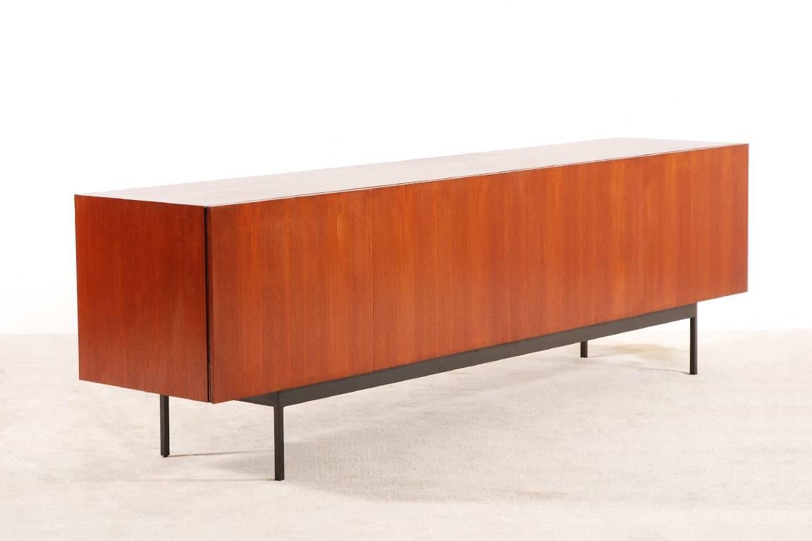 Elegant and large Dieter Waeckerlin sideboard in teak. A classic piece with a lot of space for storage.
Black lacquered metal base.

Rare Version manufactured by Idealheim Basel. circa 1958.

Excellent condition.