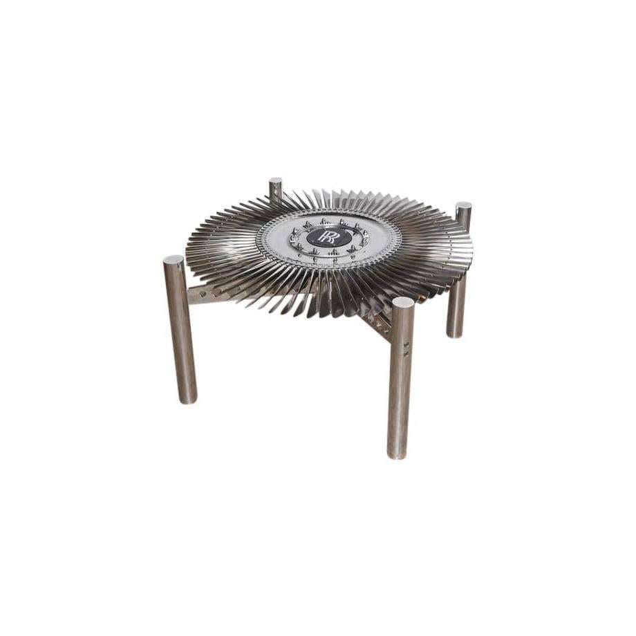 A smaller companion to our large Rolls-Royce turbine table, this smaller titanium turbine from the Rolls-Royce Pegasus engine makes an excellent coffee table. 

The turbine spins manually to catch the light and really complete the overall look of