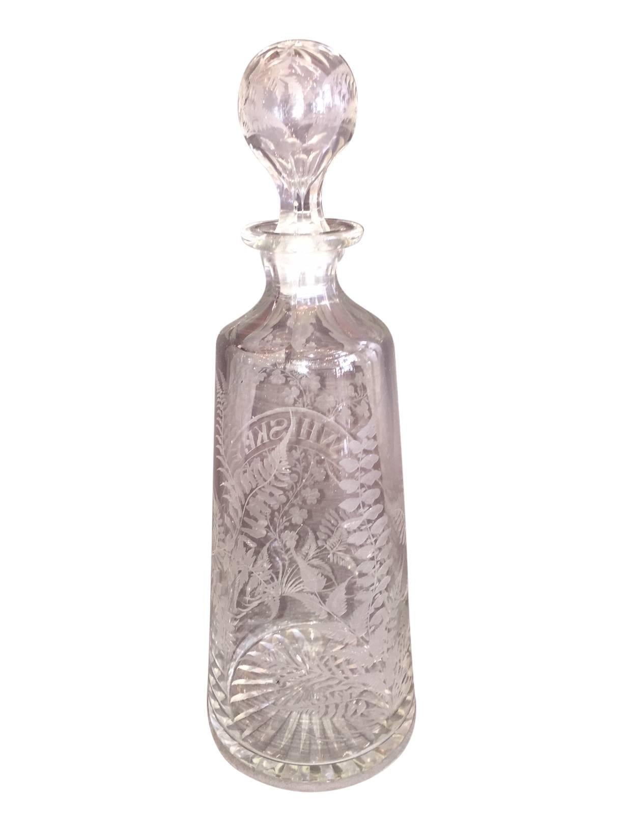 This is a beautiful late 19th century Scottish etched glass whiskey decanter. It features wonderful floral motifs.