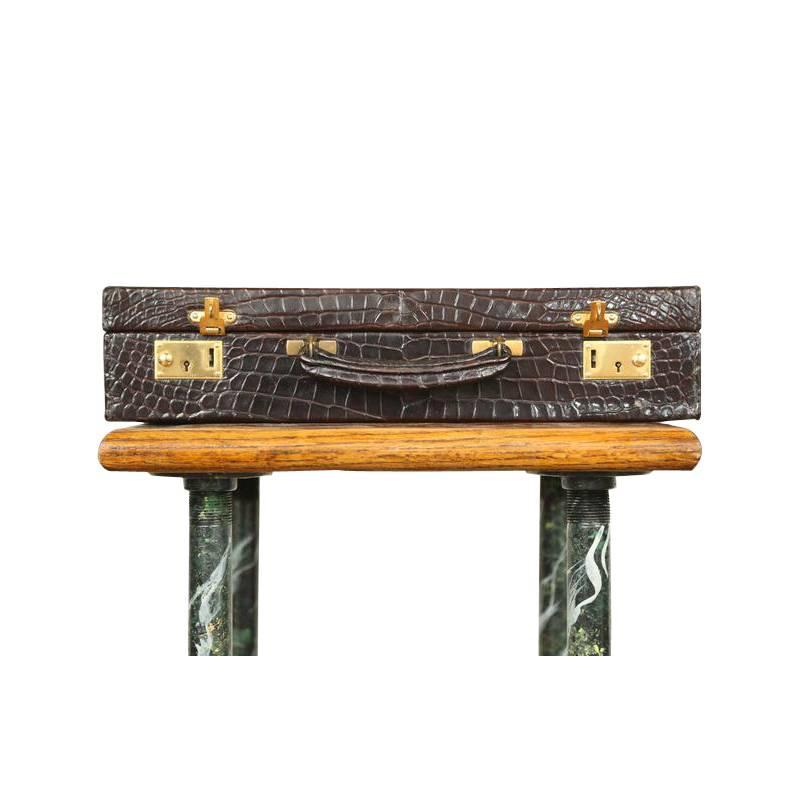 Exquisite Mid-Century crocodile briefcase produced by Asprey, the iconic London based design house. True color of the leather is a rich dark brown with burgundy hues. Exterior shows minimum wear for its age and interior is wonderfully preserved.