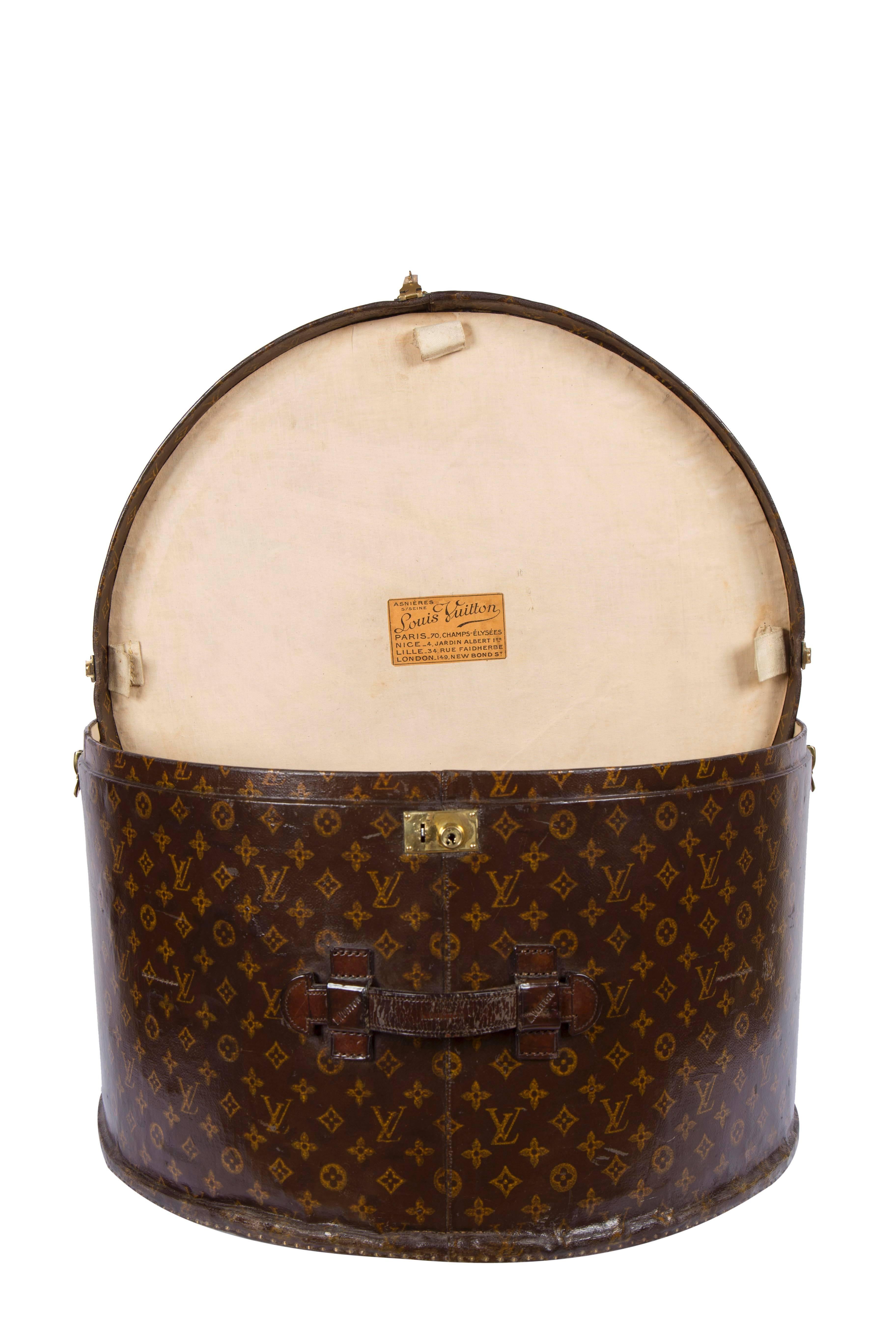 Louis Vuitton round hatbox in monogram canvas, circa 1920.  A custom ordered extra large hatbox with the initials H.B.E.  A hatbox of this size (23