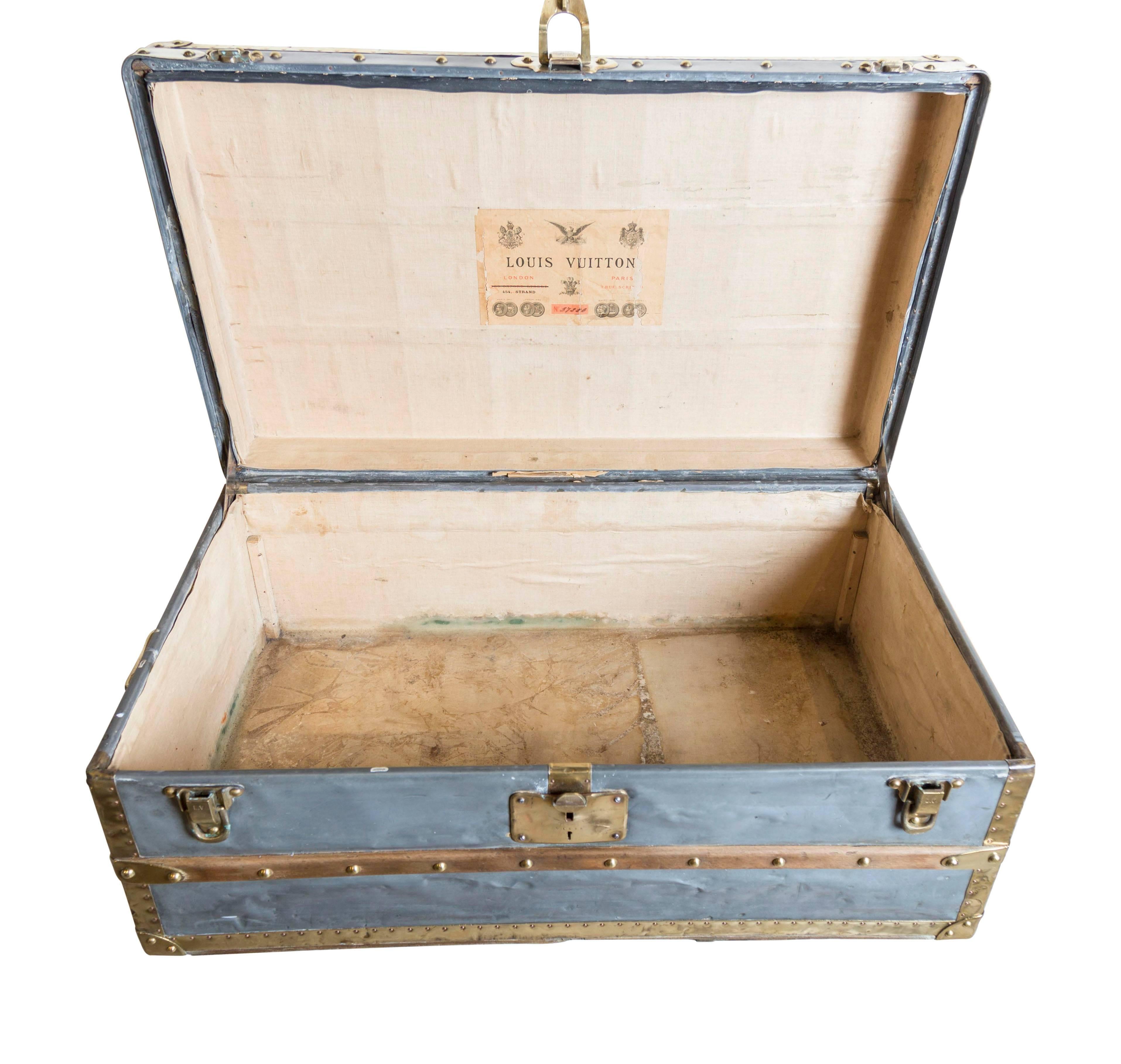 An extremely rare, and highly sought-after all-zinc covered small Malle Cabine (Cabin Trunk) with an all brass trim, LV brass studs, copper pins, brass side handles and locks, with two wooden slats to the top, and a single slat to the front. The
