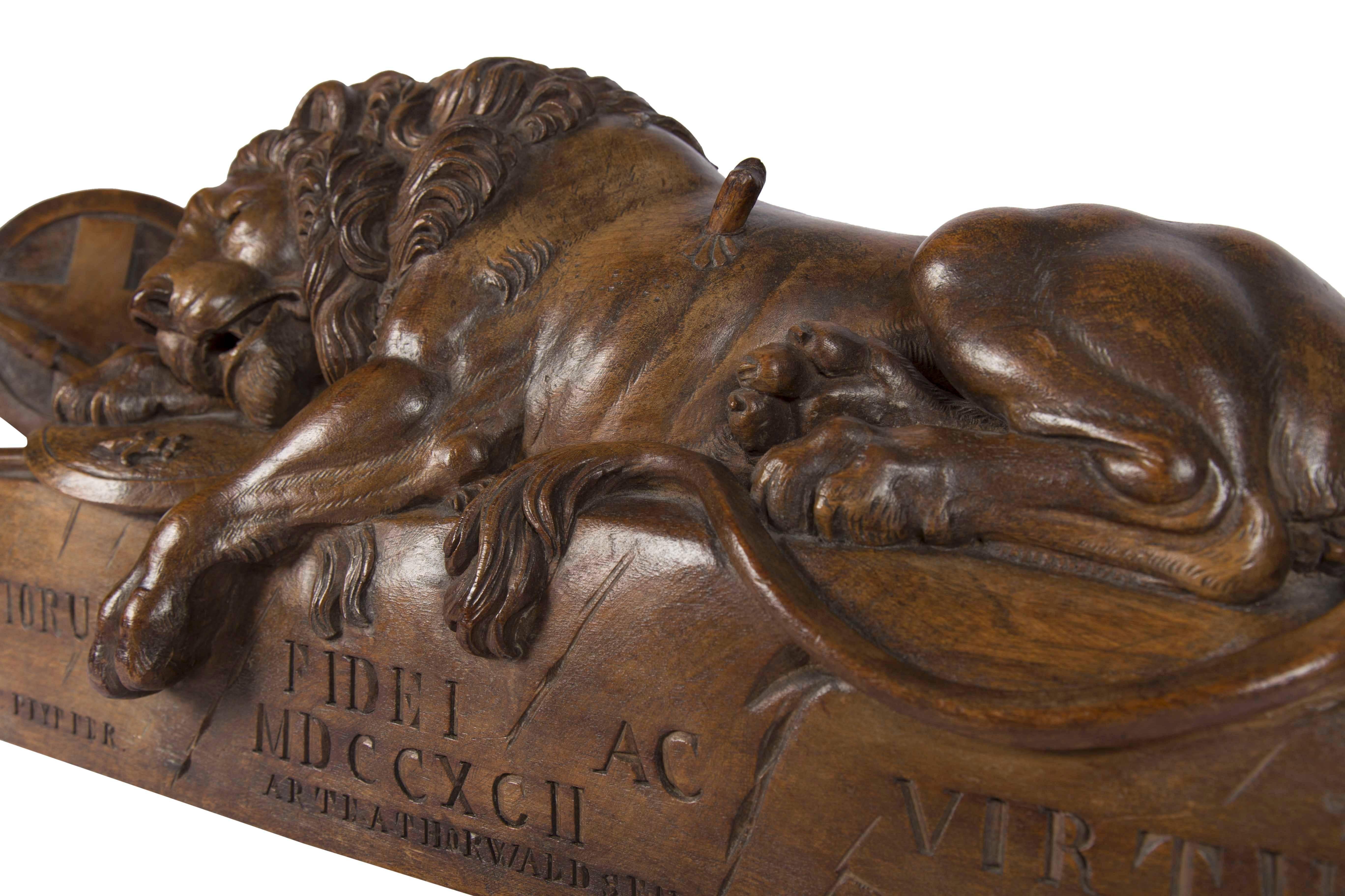 This Swiss Black Forest Lion of Lucerne Walnut Carving was originally carved by Peter Wikz of Lucerne, Switzerland. This emotional carving is modeled after the stone sculpture designed by Danish sculptor Bertel Thorwaldsen and executed by Lukas