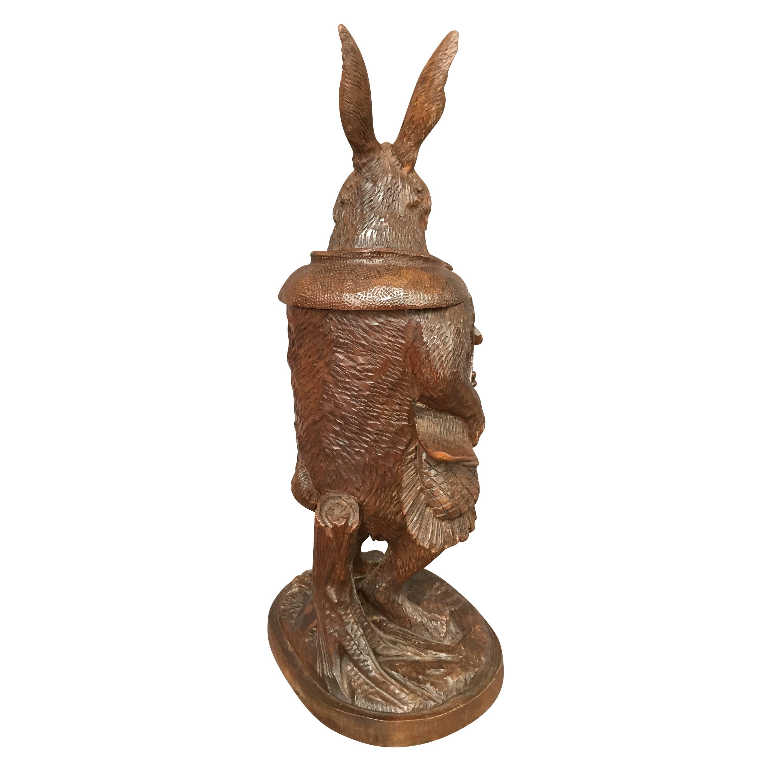 An antique Swiss Black Forest carved walnut tobacco jar modeled after a rabbit traveler. Anthropomorphized animals, such as this rabbit, were a favorite subject of the Swiss Black Forest carvers.