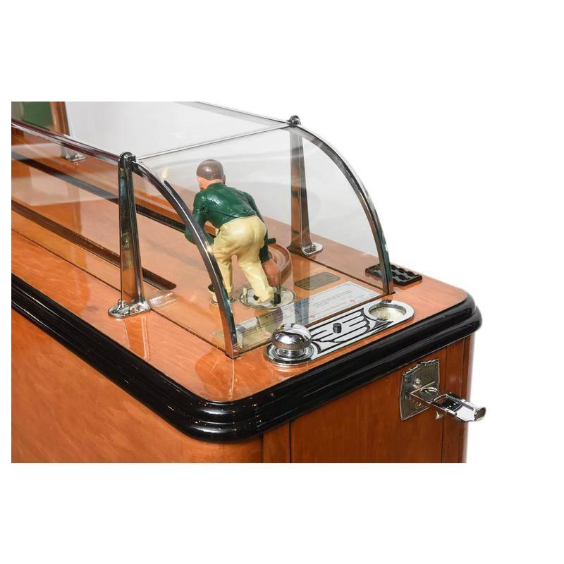 This is the first generation of the Evans Ten Pin Bowler which was produced from 1939-1942. The light-up backboard indicates pins knocked down, shows frames played, records spares and strikes and total frame-by-frame score. The pins are cleared and
