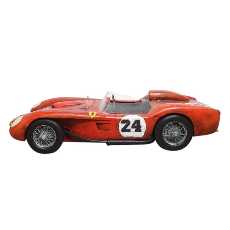 This hand carved wood model by artist Paul Jacobsen is a wonderful homage to racing and Ferrari history. The 1957 model was the test model for the entire Testa Rossa line. Translated from Italian, Testa Rossa means “red-head”, a nod to the signature
