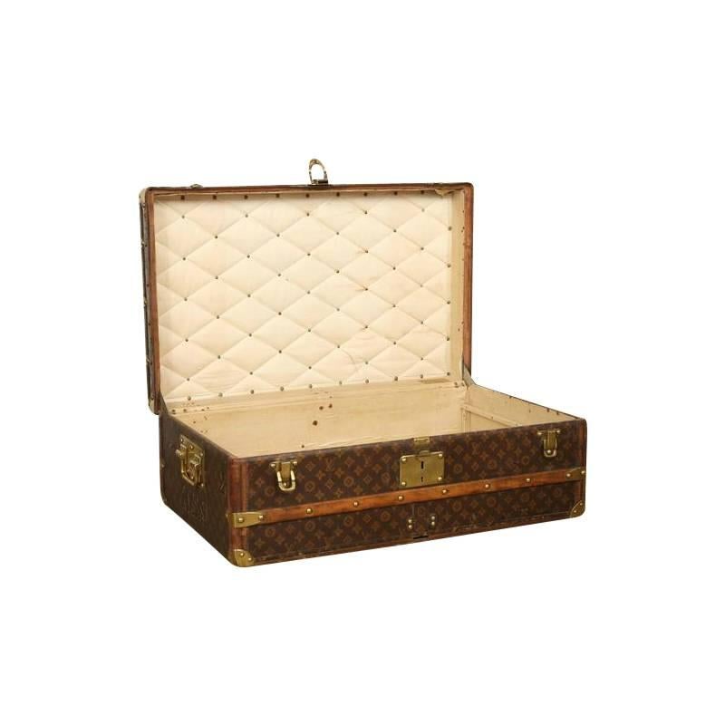 A stunning circa 1910 Louis Vuitton cabin trunk. This trunk size was designed to go under the berths of ships. It is also a most popular size for a custom Louis Vuitton coffee table. It features beautiful brass accents, and a hand-stenciled monogram