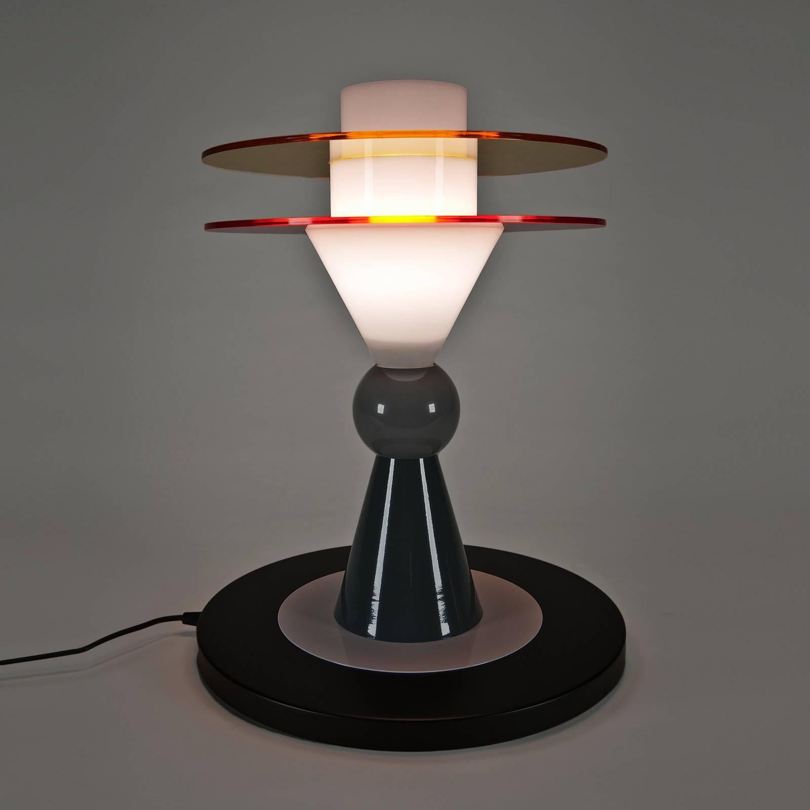 Ettore Sottsass, the founder of Memphis, designed this lamp for the Memphis 1983 collection. This example from 2010-2015 production. Includes bulb (1- 42w, E27 base, 230v - 50 HZ). Black electrical cord. Memphis identification tag on back of base.