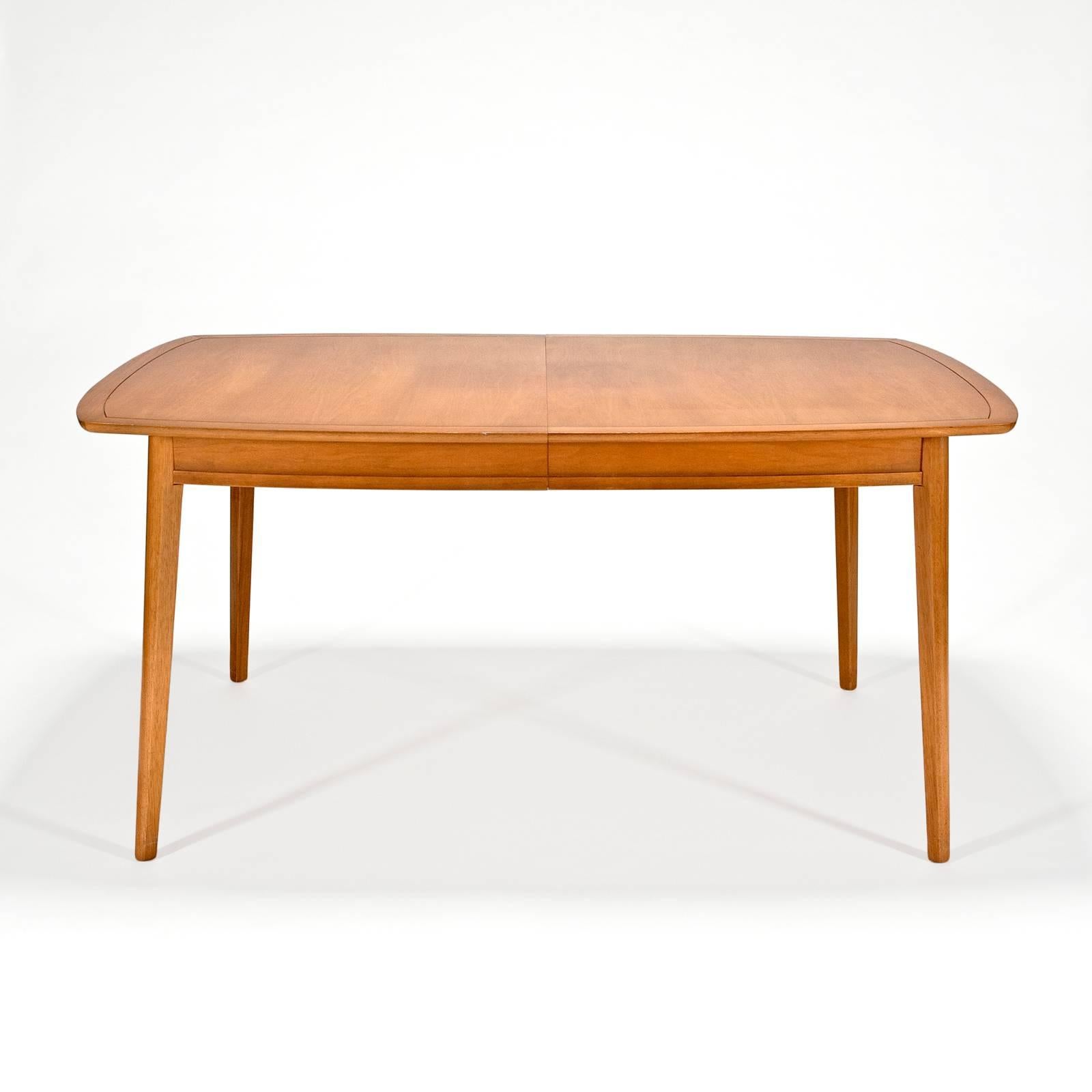 Dining table in butternut wood with two matching arm chairs and four side chairs. Table measures 60 long with 40 wide tapering to 35.5 at the ends. Armchairs are 34 high by 21.5 x 21.5 with 17 seat height. Side chairs are 33 high x 18.25 x 20.5 and