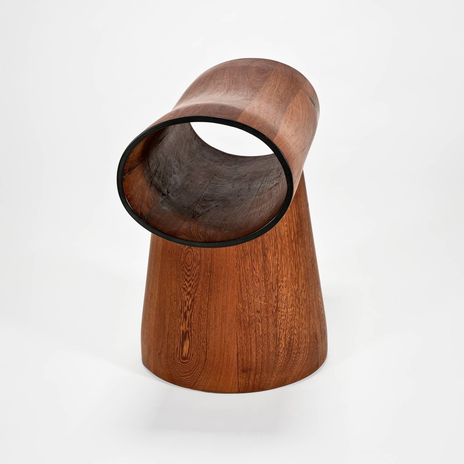 This stool is handmade by Mabeo craftsmen using an involved process of wood lamination, turning and sculpting. This example has a natural finish and a black trim paint to accentuate the edge. It is made from sustainably harvested hardwoods to be