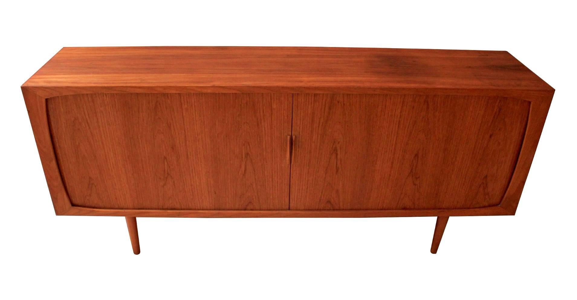 1960s Danish Modern teak credenza or buffet with tambour doors. Credenza has three adjustable shelves and a large central storage compartment.