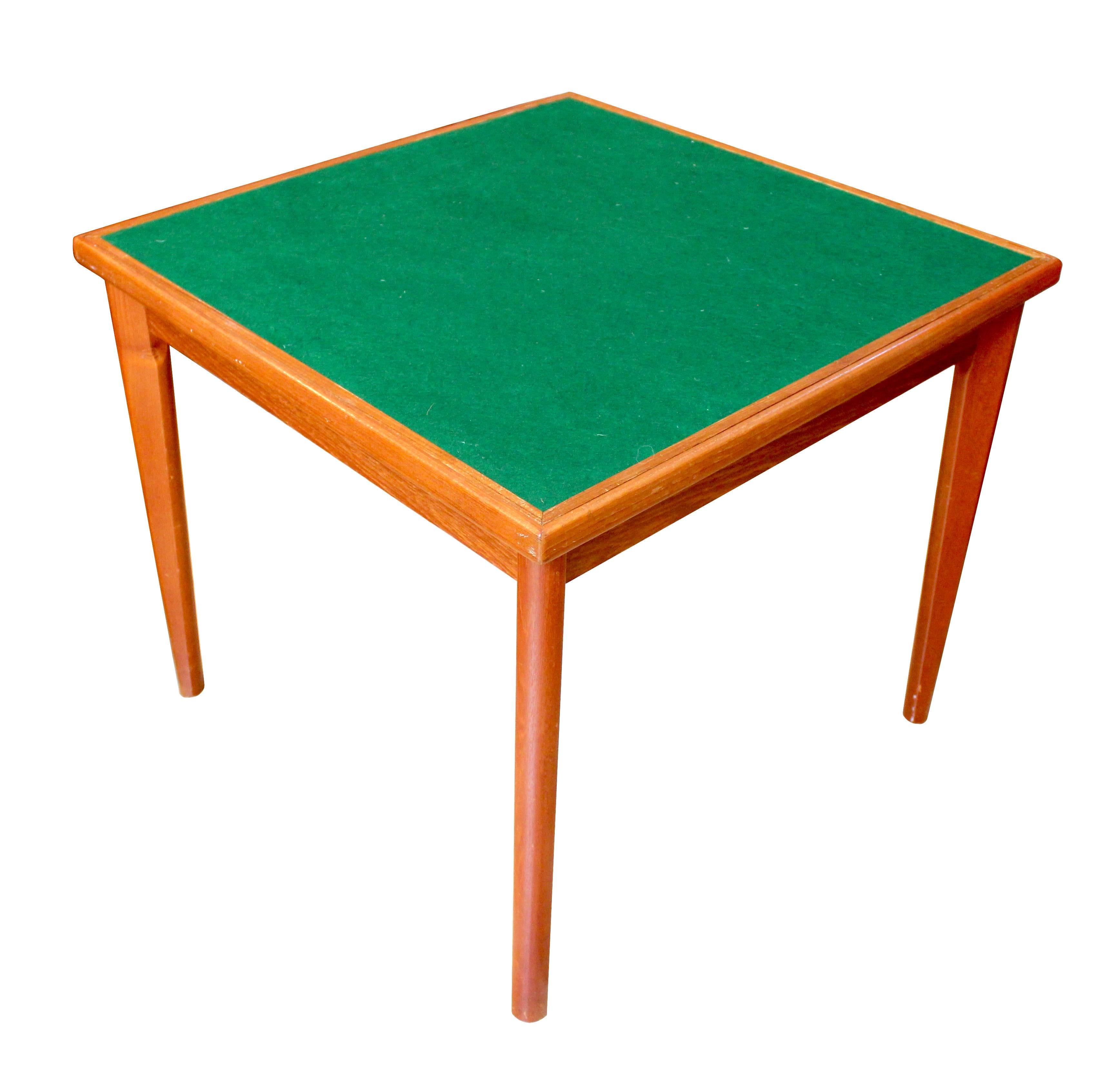1960s Danish Modern teak game table with reversible top by Brdr. Furbo. The tabletop lifts off, with teak on one side and green felt on the other. A unique piece that functions equally well as a small dining table and a game or card table.