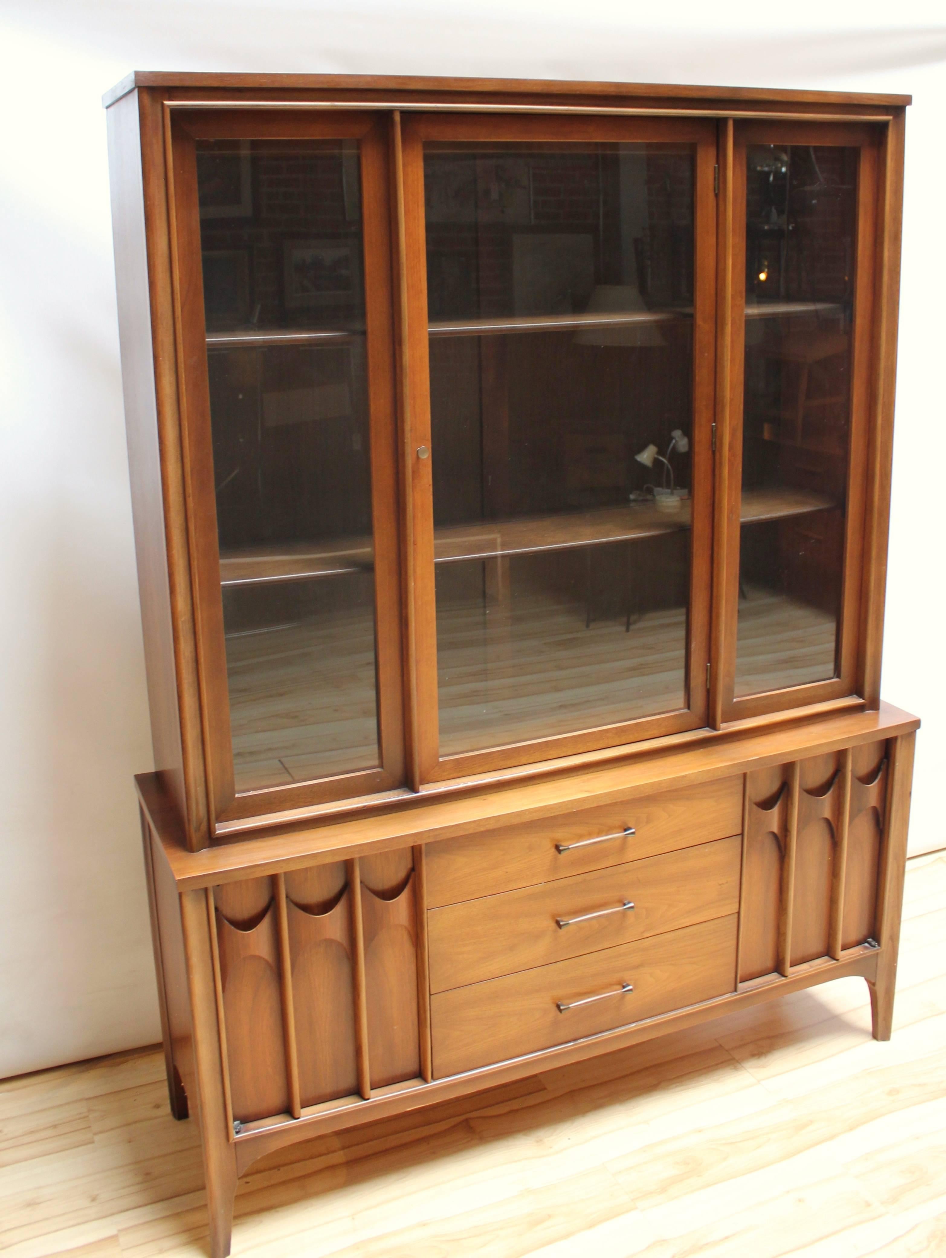 Mid-Century Modern china hutch designed by Kent Coffey for the Perspecta series. The hutch top is has glass windows and door, and the bottom features three drawers and two side cabinets.
