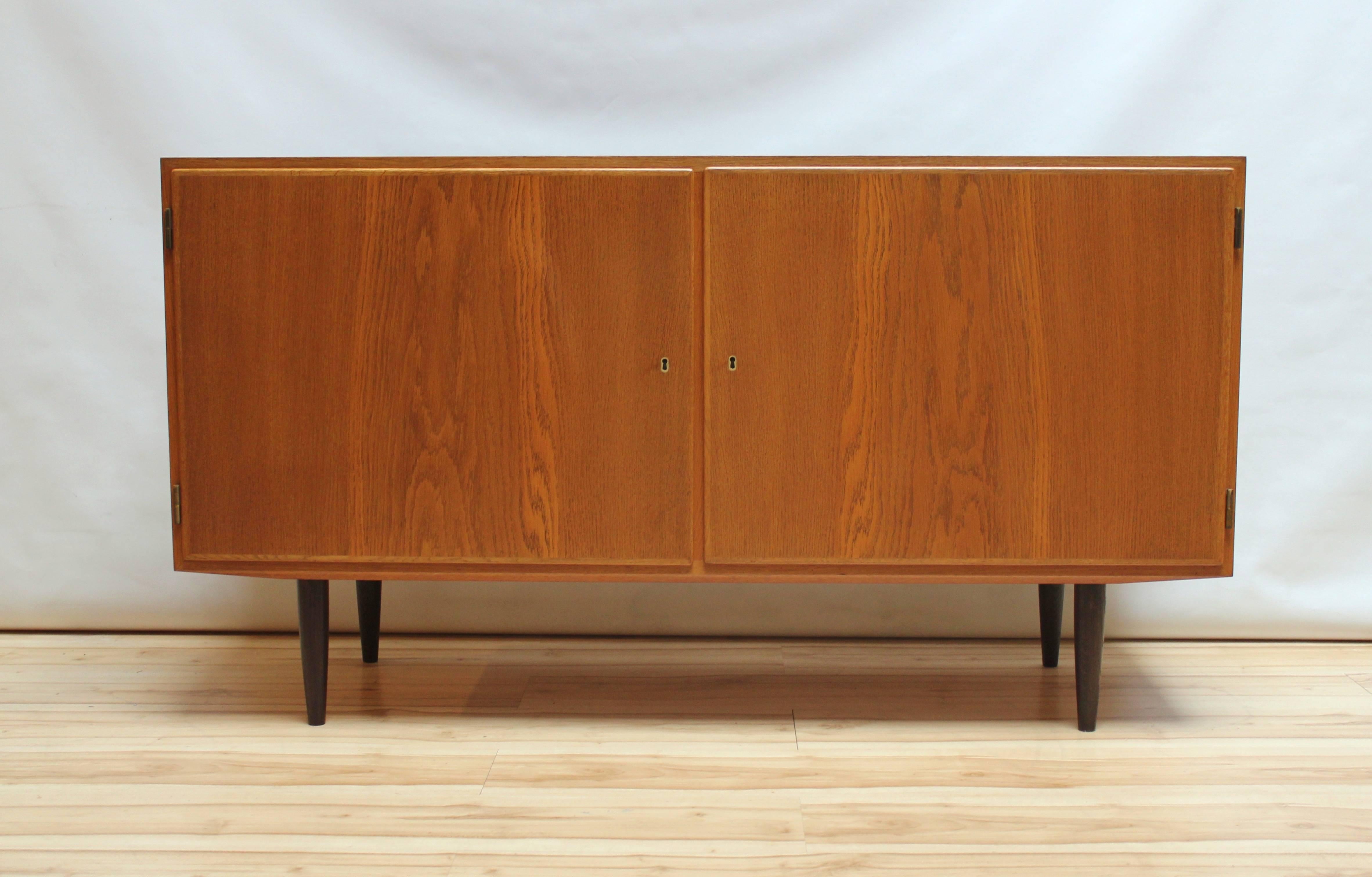 1960s Danish Modern credenza/buffet by Poul Hundevad, The credenza features two locking doors with six drawers on one side and an adjustable shelf on the other. Very clean, Classic lines, with nothing unnecessary or inessential.