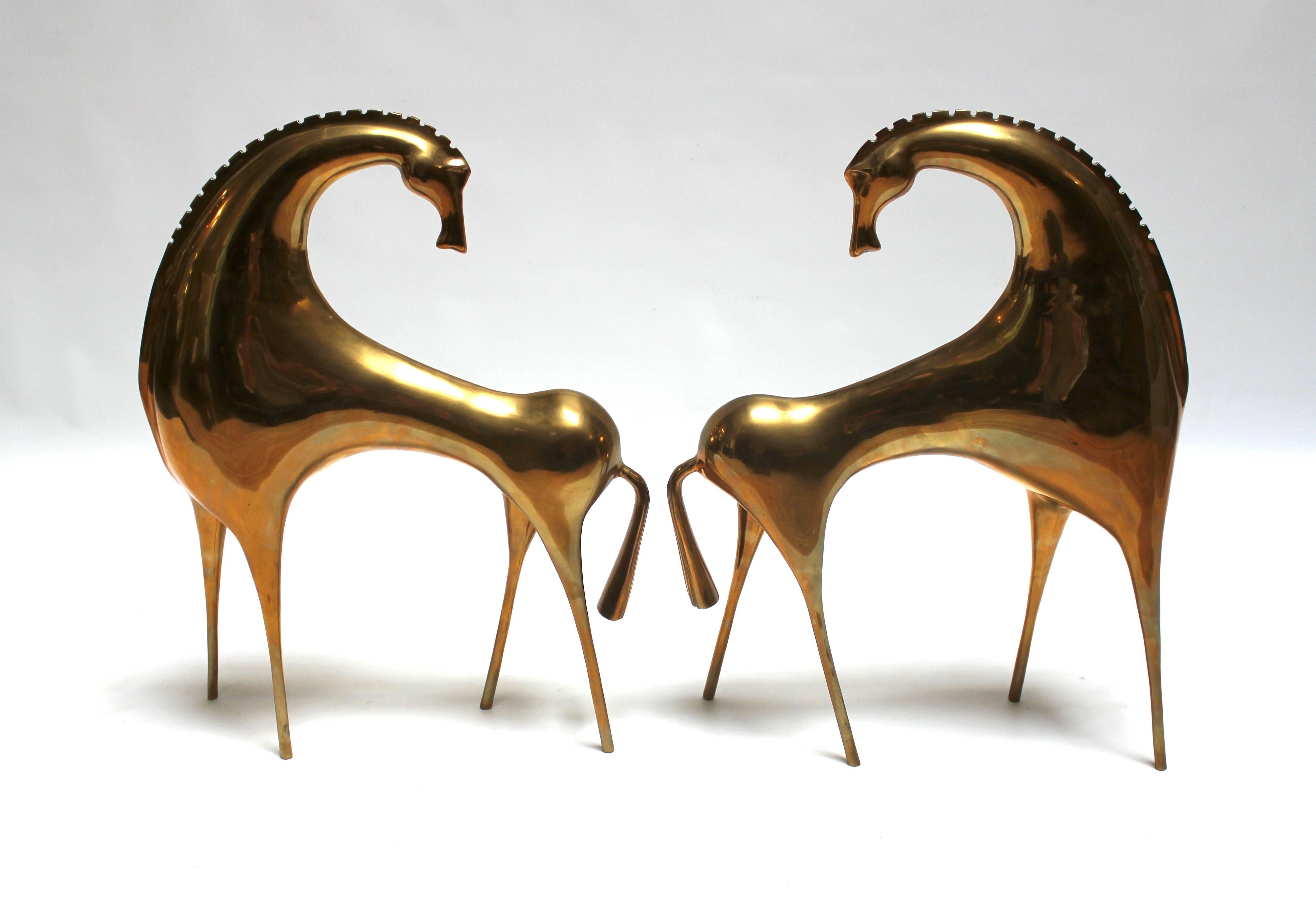 Pair of early 1980s sculptural brass horses, similar in style to Frederick Weinberg. Very striking, somewhat abstracted design, with elements of Mid-Century, Hollywood Regency, and Postmodernism. Price is for the pair.