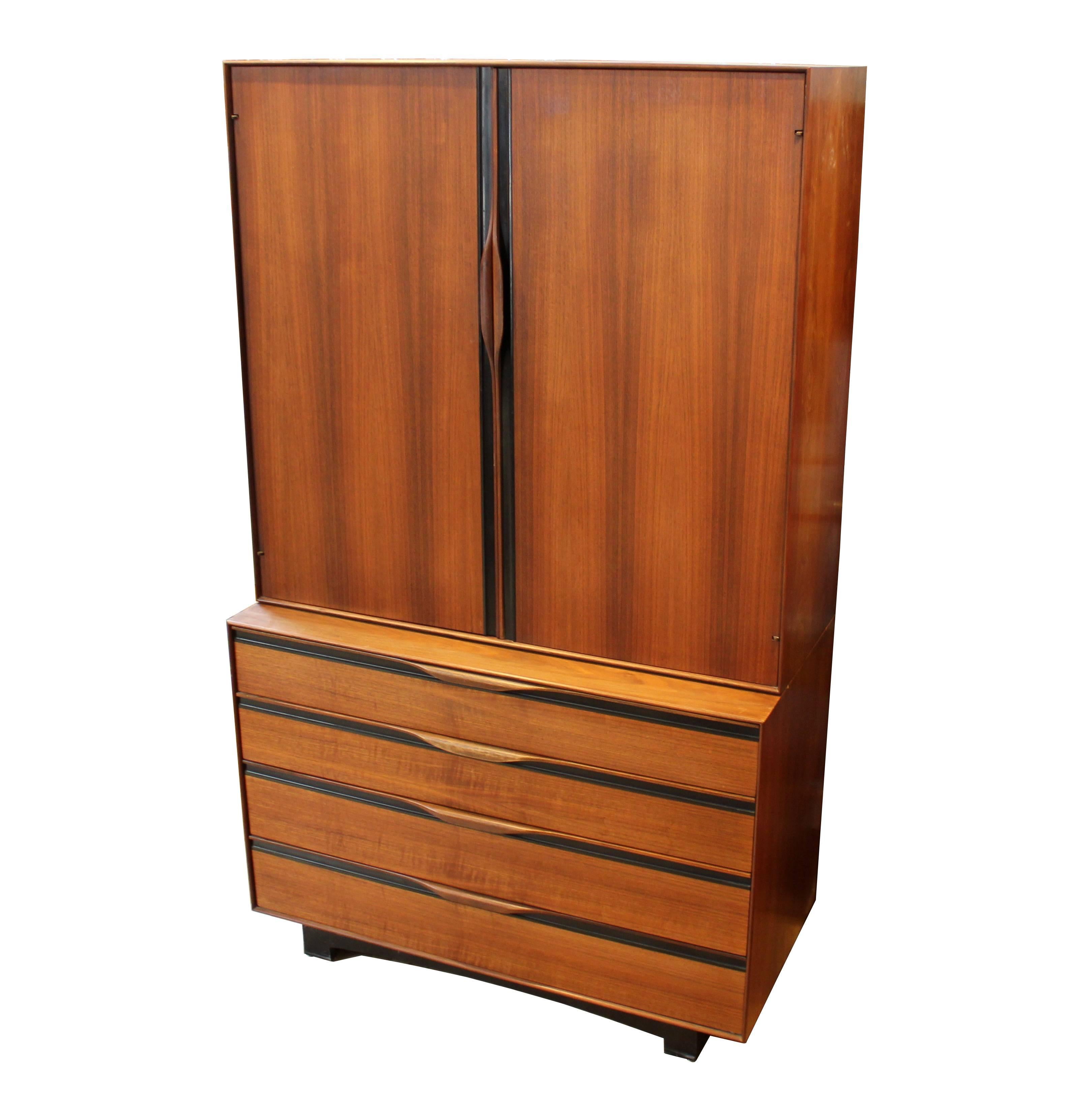 1960s walnut gentleman's chest by John Kapel for Glenn of California. The piece is composed of a lower dresser and an upper cabinet with three drawers, adjustable shelves, and a mirror which swings out for more storage. An elegant and practical