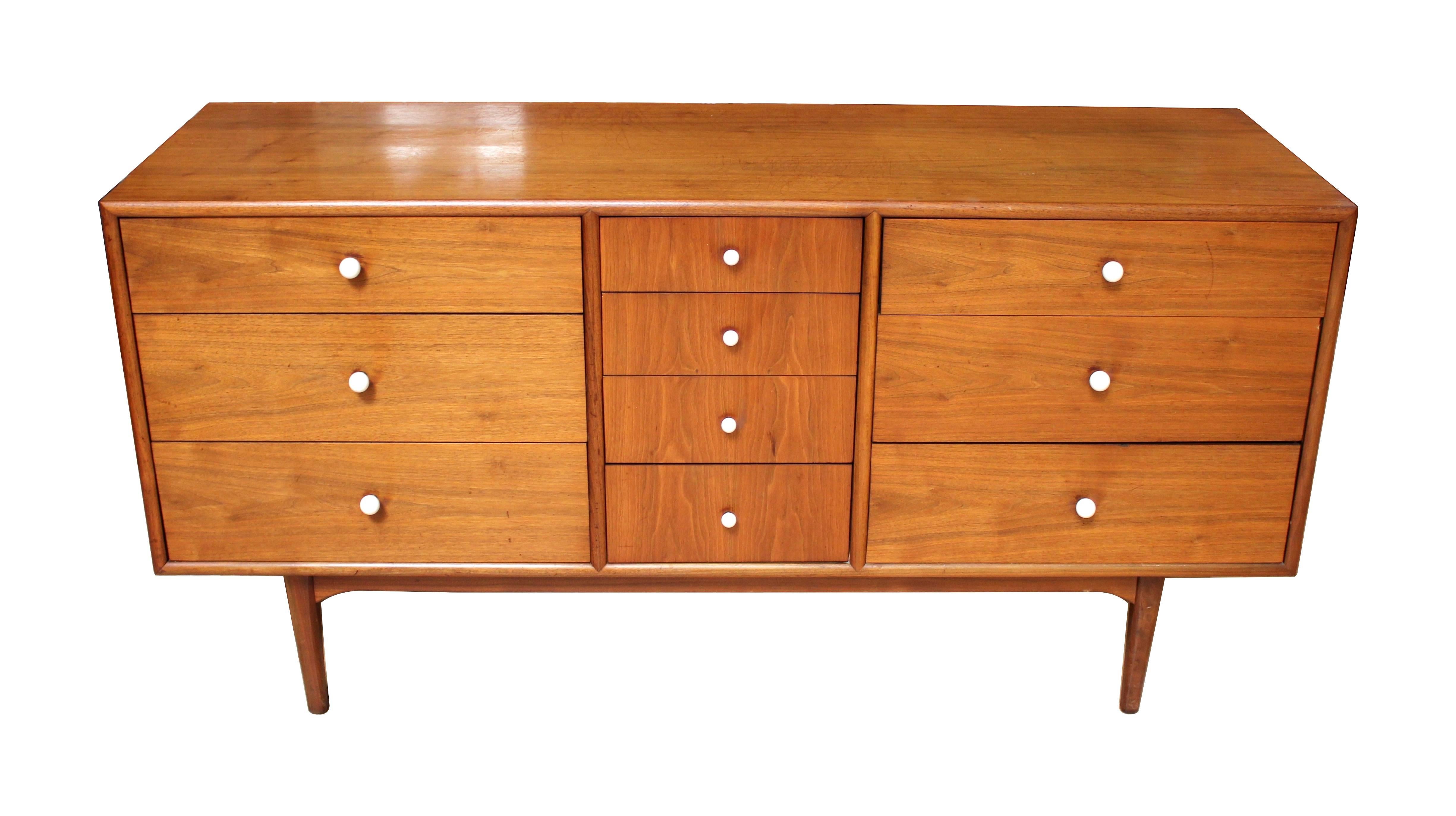 1964, ten-drawer walnut dresser designed by Kipp Stewart and Stewart McDougall for Drexel Declaration. Beautiful walnut wood grain and the signature declaration white porcelain pulls. Some light scratching to top, as shown in pictures.
 