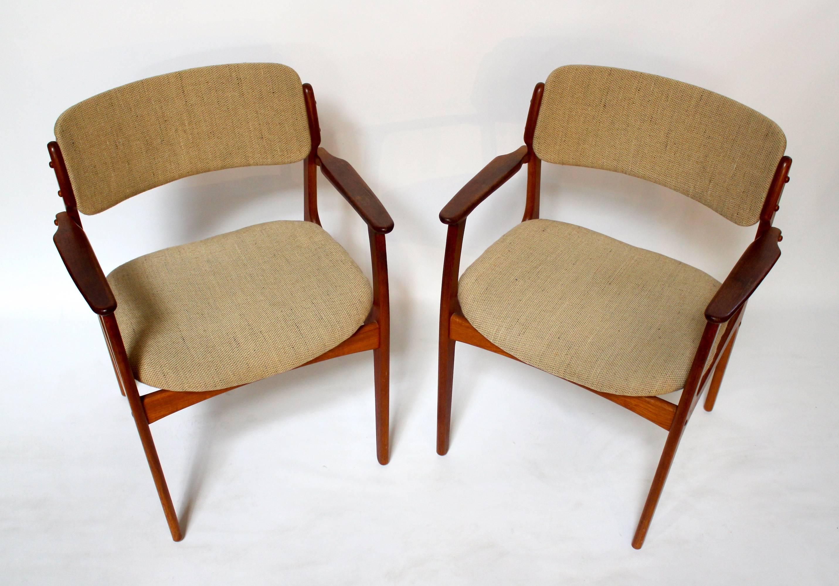 Pair of Danish modern OD-49 teak armchairs by Erik Buch for Oddense Maskinsinedkeri. Chairs have original upholstery and foam. In good condition with no fading or tears, though the seat backs have very little padding. Price is for the pair.