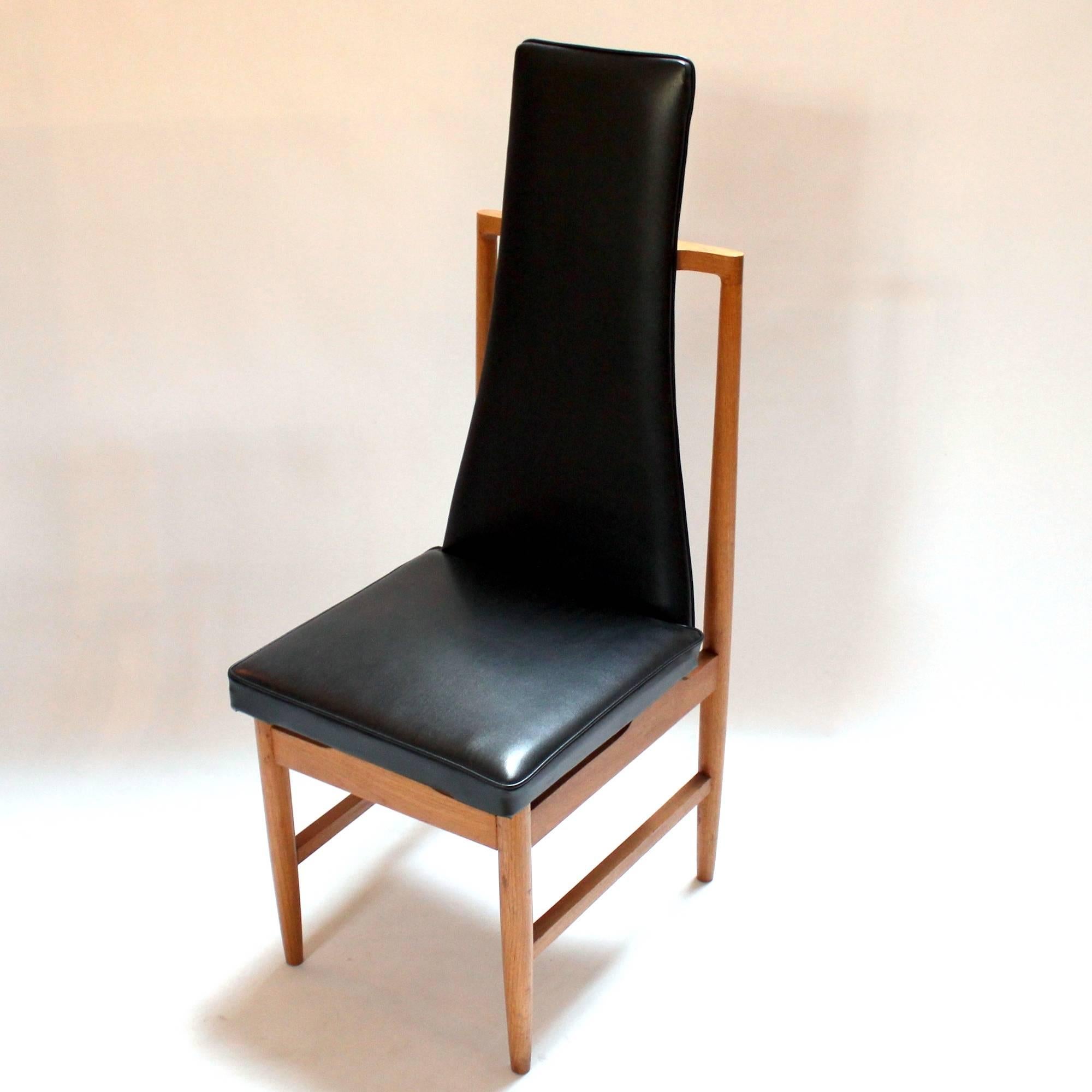 Set of four 1960s Danish Modern teak and vinyl tall-back dining chairs. Unusual space-age design, in excellent condition. Price is for the set.