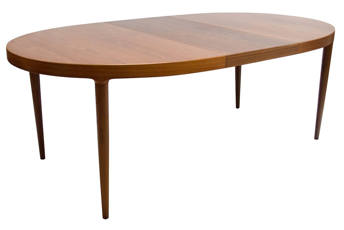 1960s Danish Modern walnut dining table designed by Skovmand & Andersen for Moreddi. The table has four leaves, each measuring 19.75