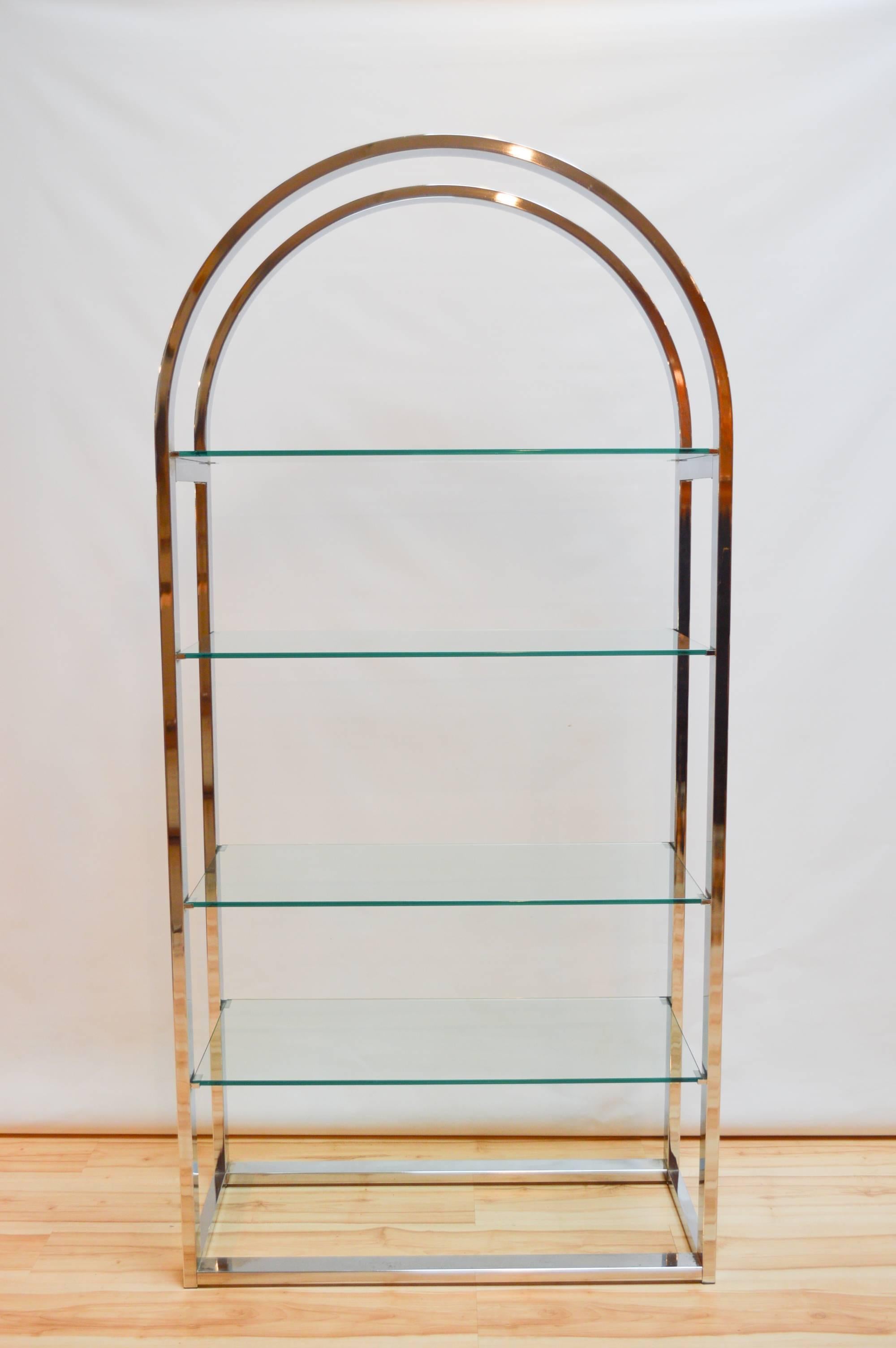 Mid-Century Modern glass and chrome arched etagere in the style of Milo Baughman. Etagere has four 1/4"-thick glass shelves.