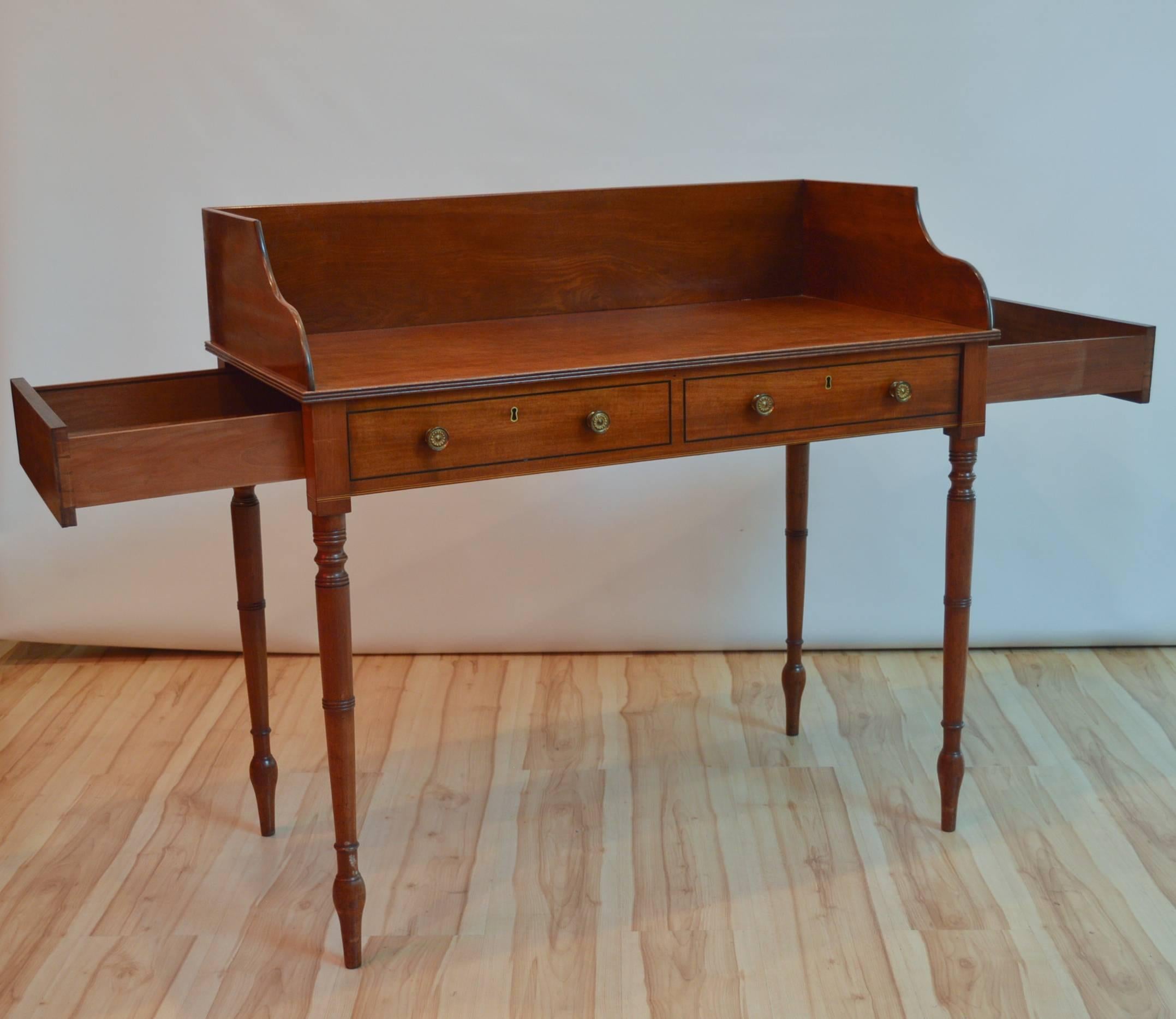 Cuban mahogany American writing desk, most likely manufactured in Massachusetts in the early to mid-1800s. The desk features a false front and 