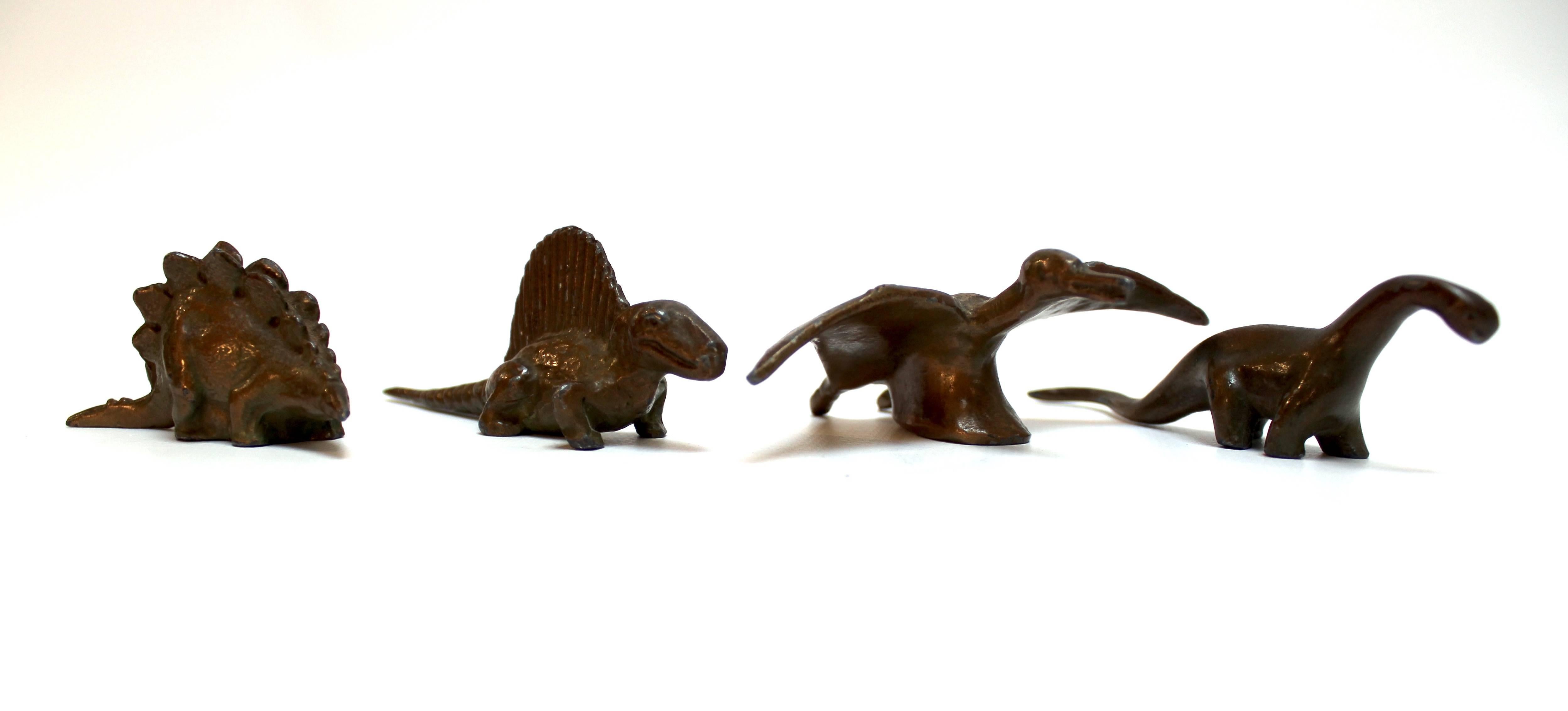 Set of 4 vintage bronze dinosaur toys manufactured by Sell-Rite Gift Company (
