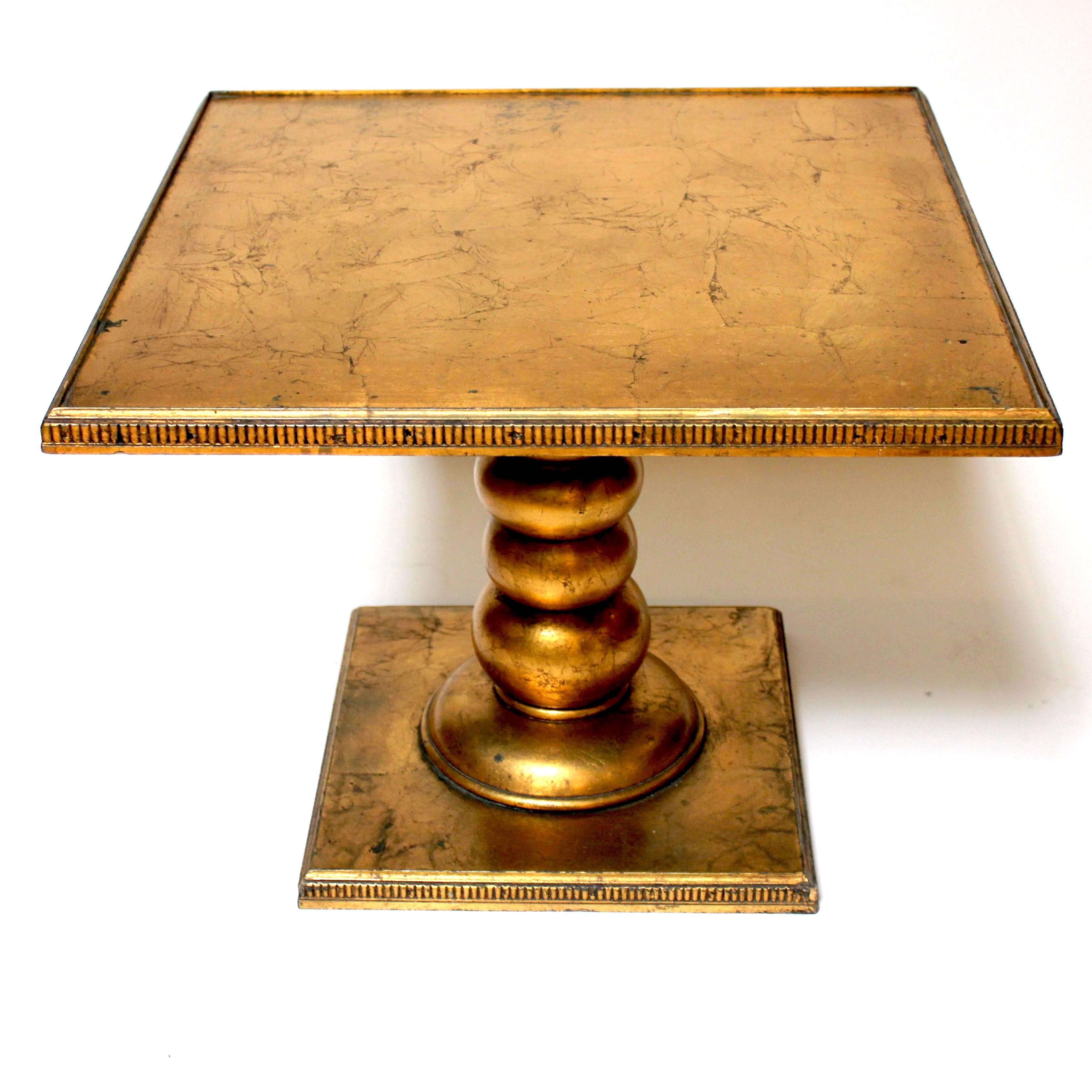 Vintage Hollywood Regency gold leaf end table. A Classic and elegant design, with a beautiful gold luster. The table includes a glass panel, not pictured, to protect the tabletop.