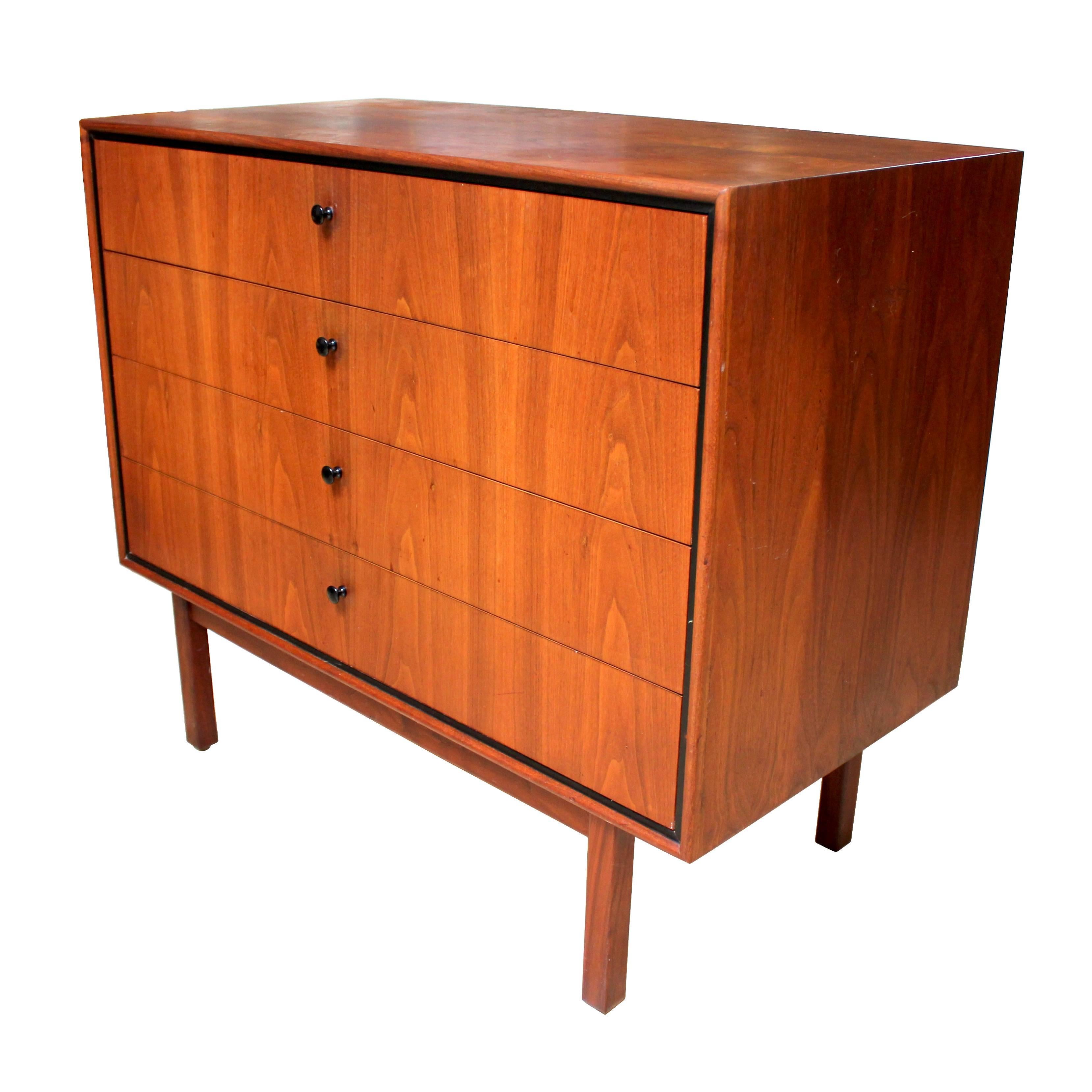 1950s walnut four-drawer dresser or chest of drawers designed by Milo Baughman for Arch Gordon. In excellent condition with black trim and grain matched drawer fronts. A beautiful example of Baughman's work for Arch Gordon, a collection much less