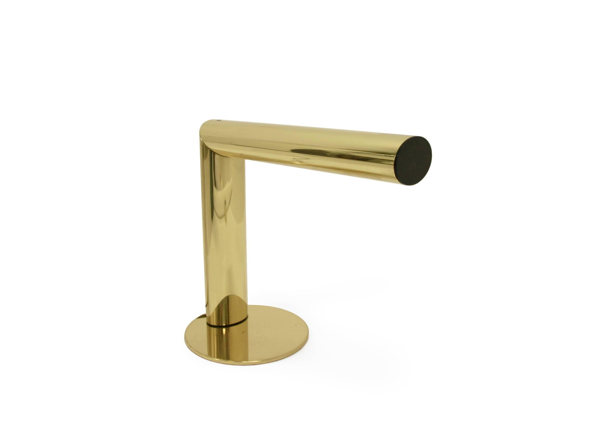 Wonderful and minimalist table lamp on a brass frame with revolving lamp shade.

Designed by Jonas Hidle and made by Høvik Lys AS, Norway, circa 1980 second half.

The lamp is a remarkable example of Norwegian post modernist design produced in a