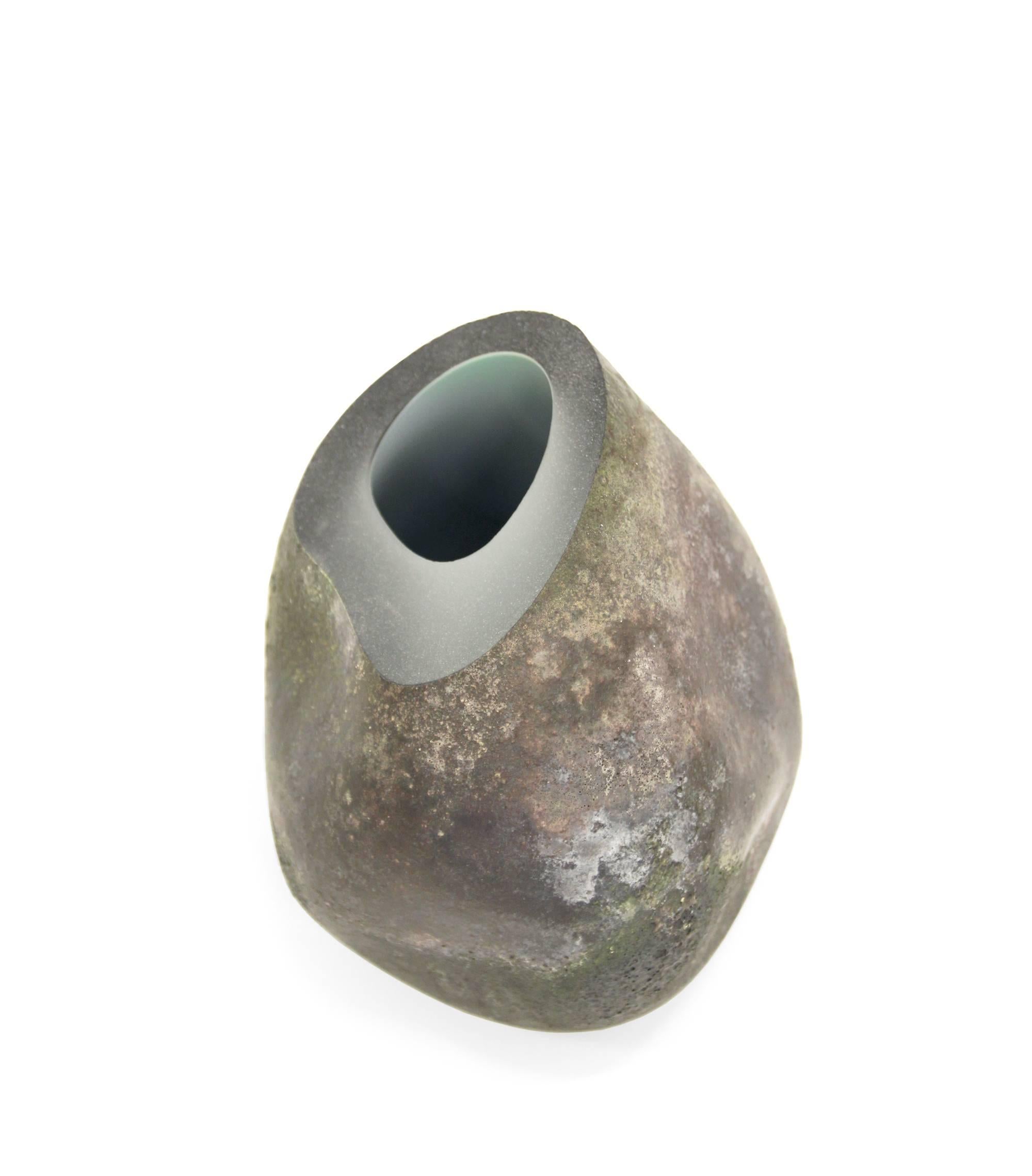 Studio work glass vessel with a smooth inner core and rocky outer surface.

This piece is part of the IM series by Nustad which beautifully expresses the contrasting light and shapes the nordic nature.

The interplay between the intense rocky