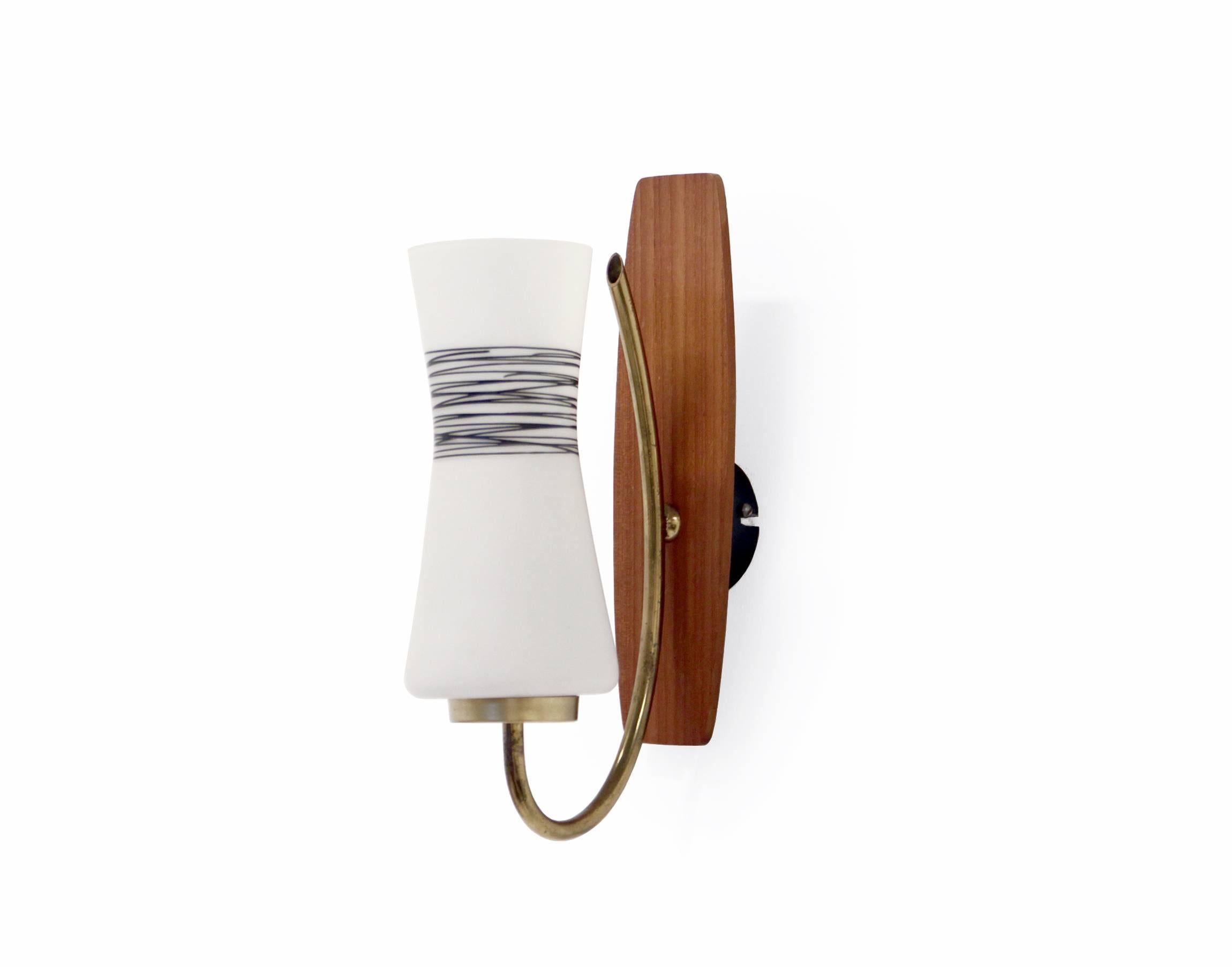 Beautiful set of wall lights on a teak and brass frame. Opaline glass shade with a minimalist surface decoration.

Designed and made in Norway by Garder Lys AS from, circa 1960 second half.

Both lamps are fully working and in good vintage