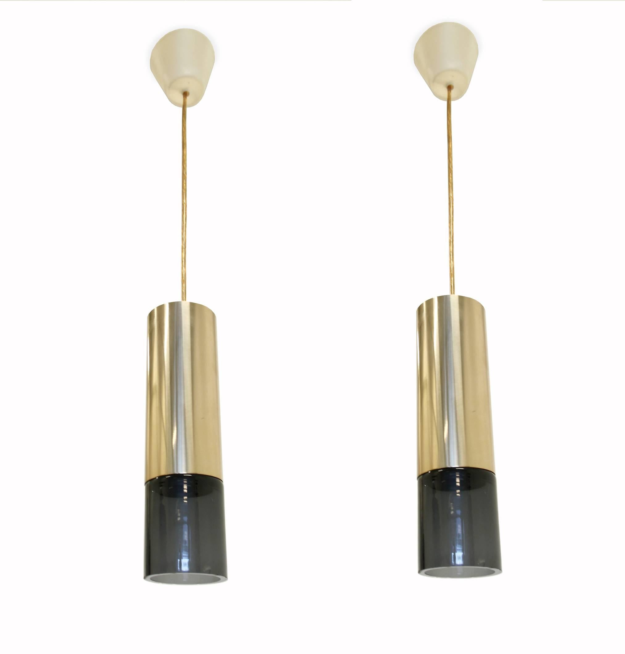 Beautiful and well-made pair of pendants lamps on a brass frame and glass shades.

Made in Norway by Sønnico AS and most likely designed by Kjell Munch, circa 1960s second half.

Both lamps are fully working and in good vintage condition. Some