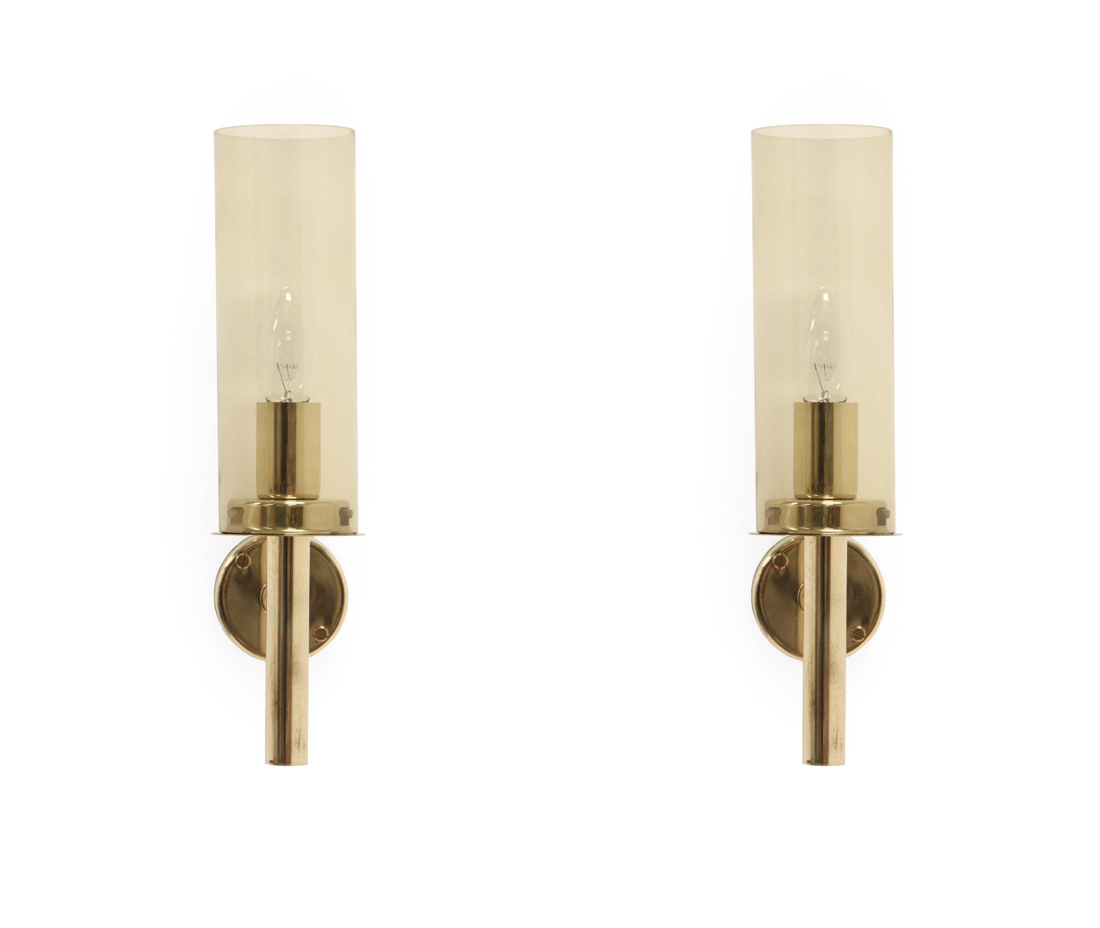 Graceful and modernist wall lamps in brass shades in coloured glass.

Model '169/14'. Designed and made in Sweden by Hans-Agne Jakobsson from circa 1960 second half.

Both lamps are fully working and in good vintage condition with some traces of