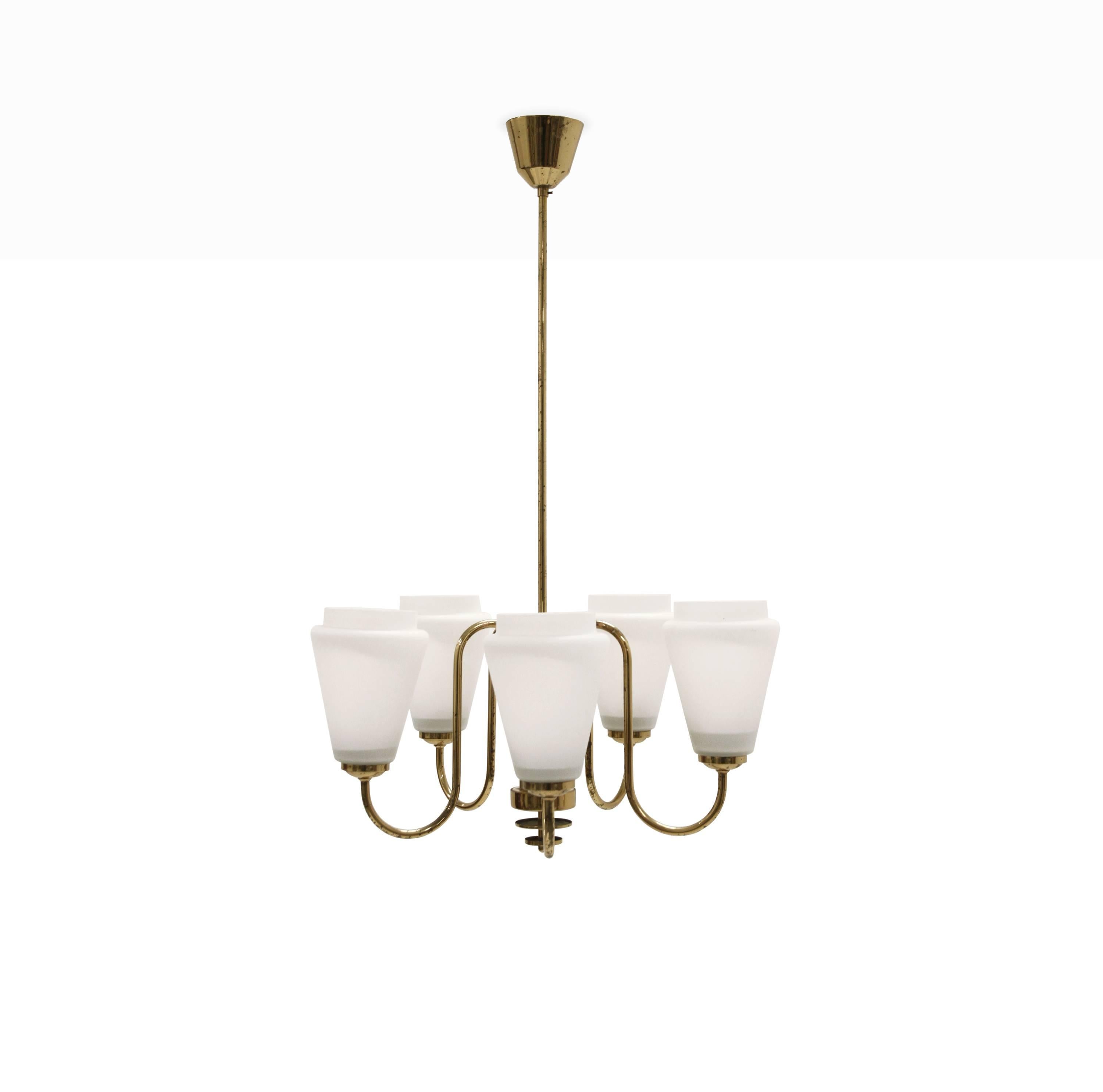 Delightful and appealing five armed chandelier in brass with shades in opaline glass.

Most likely designed and made in Sweden from circa 1960s first half.

The lamp is fully working and in good vintage condition with normal signs of wear and