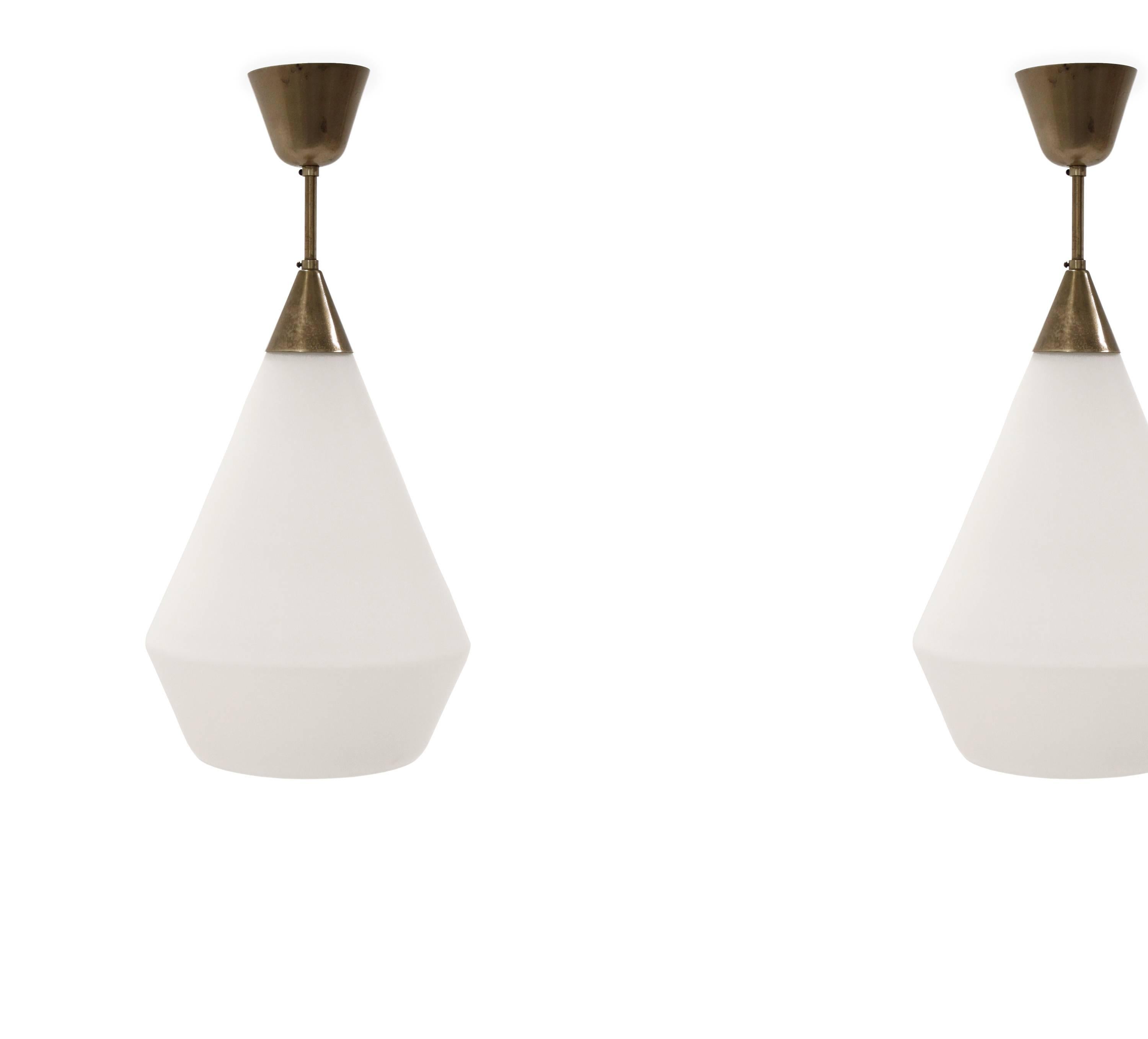 Pair of large ceiling pendants with shades in opaline glass and brass stem.

Designed by Birger Dahl and made in Norway by Sønnico in the late 1960s.

Both lamps are fully working and in good vintage condition.