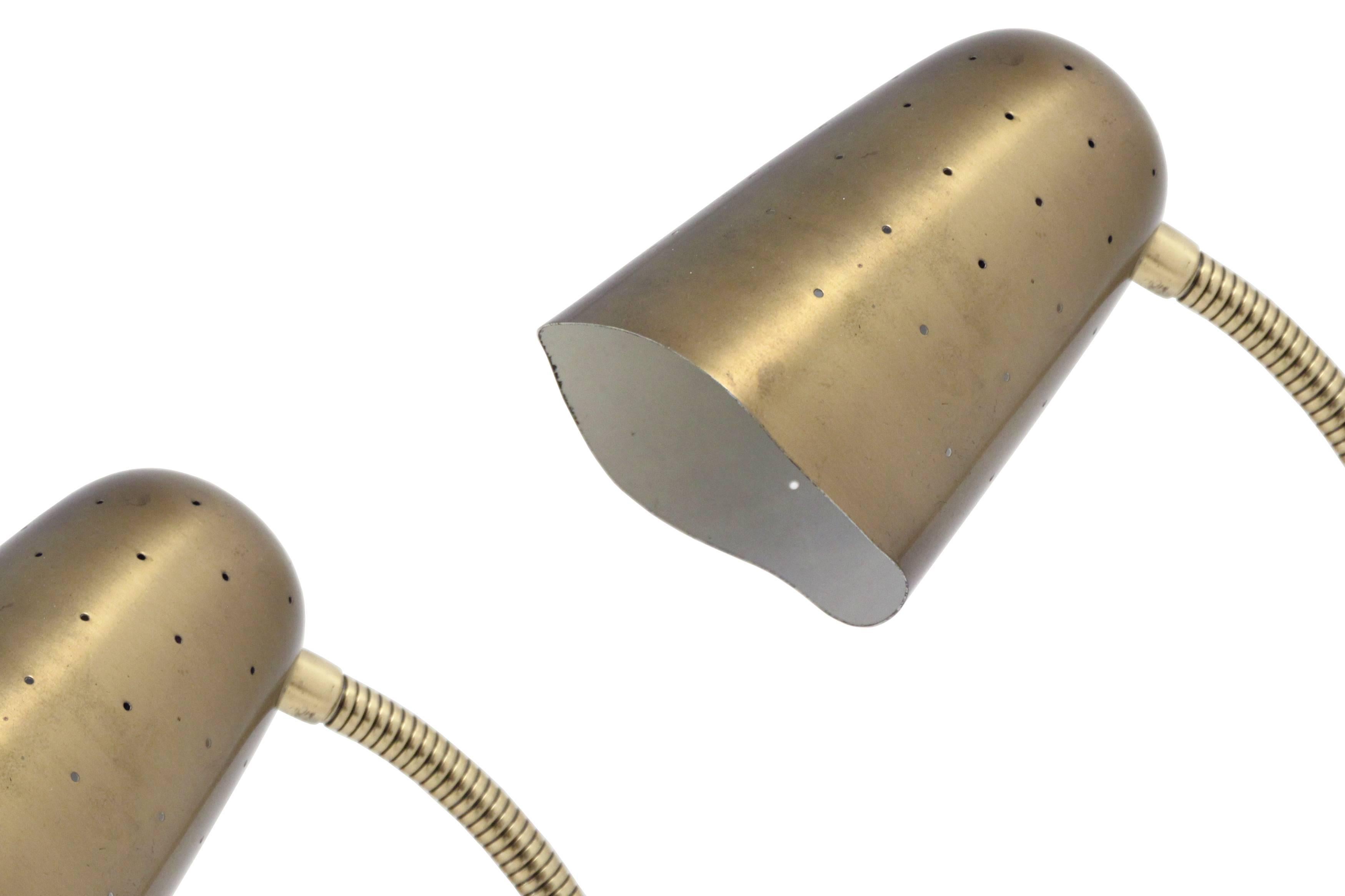 Wonderful and articulate pair of wall lights in brass. Designed and made in Norway by Arnold Wiig's Fabrikker from 1960s first half. Both lamps are fully working and in excellent condition.