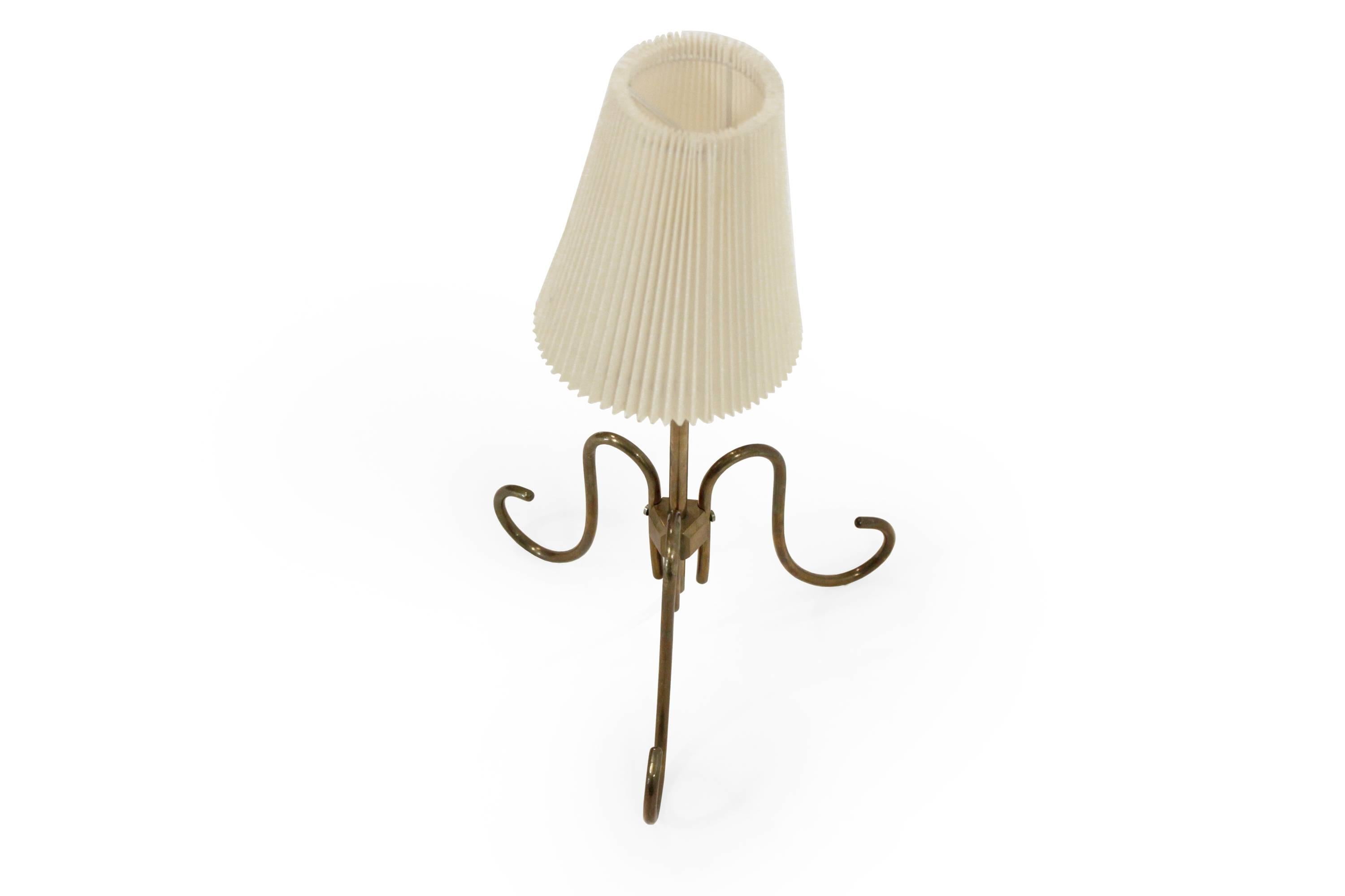 Decorative and graceful table lamp in brass.

Most likely designed and made in Sweden from circa 1960s second half.

The lamp is fully working and in good vintage condition.