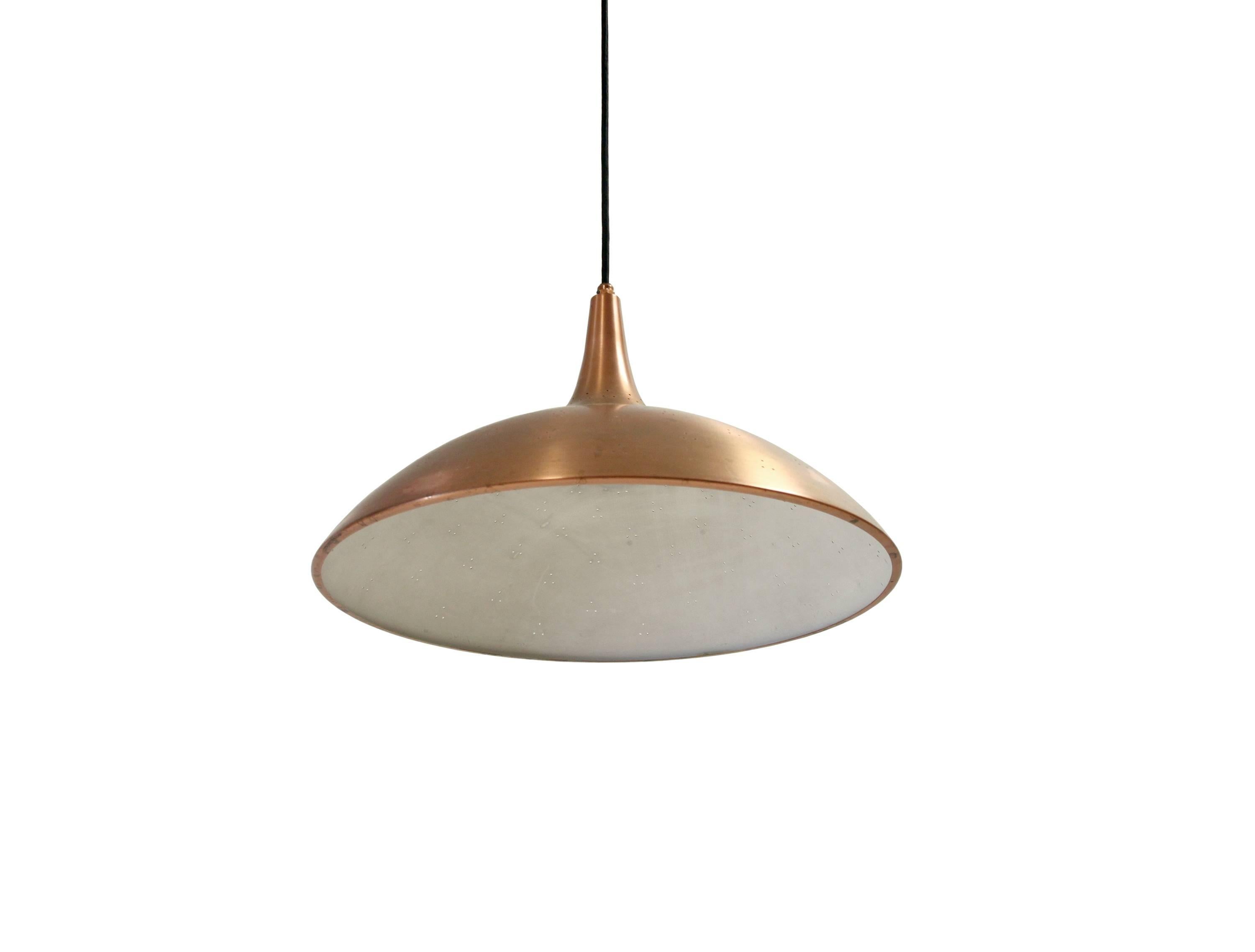 Wonderful pendant lamp in perforated copper. This is model no. J1965, designed by Paavo Tynell for Taito and in production from ca 1950s second half.
These lamps were mainly made in brass. However, this particular model is in copper and is made in