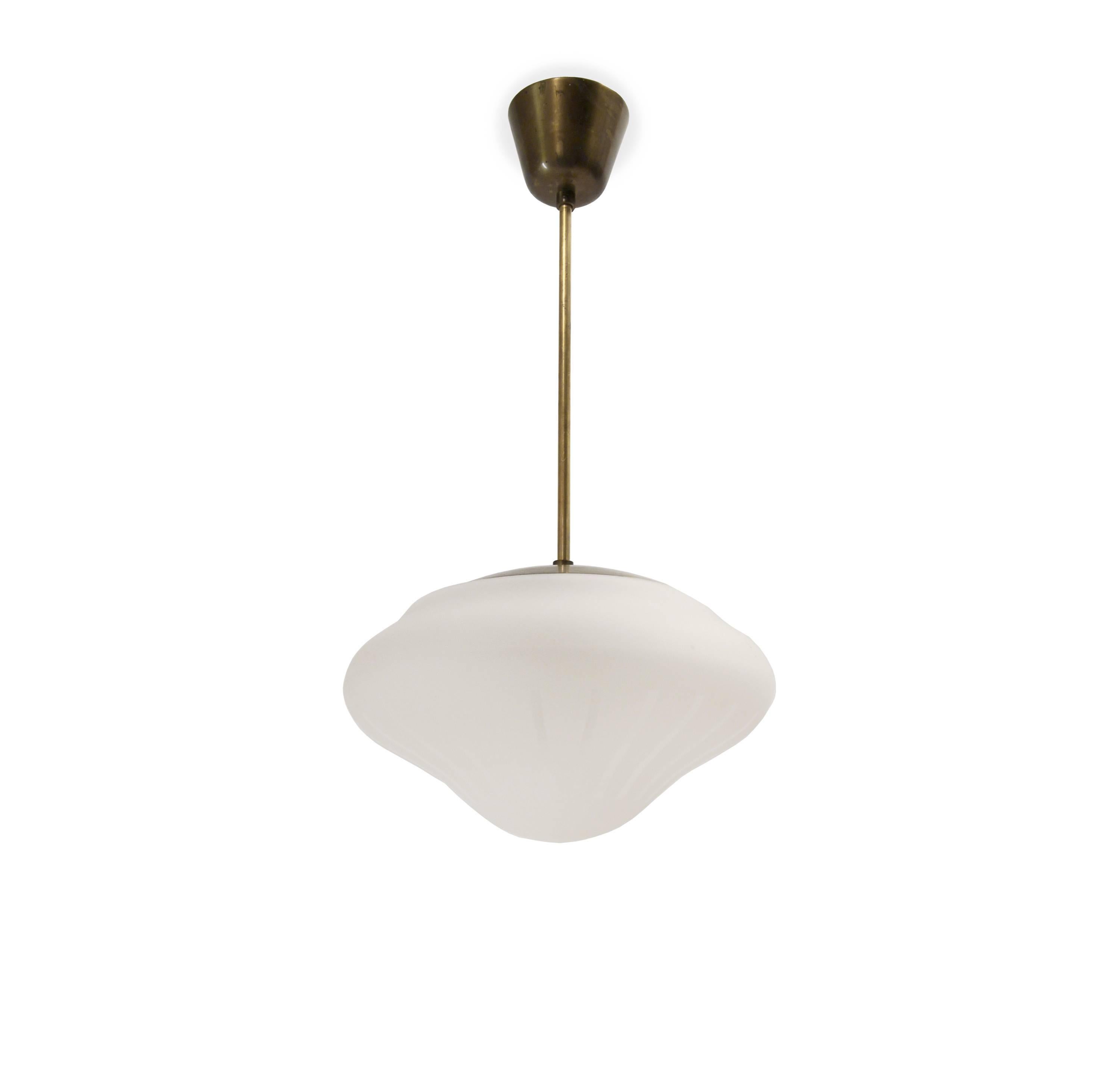 Decorative ceiling light in frosted glass and stem in brass. Designed and made in Sweden from circa 1950s first half. The lamp is fully working and in excellent vintage condition.