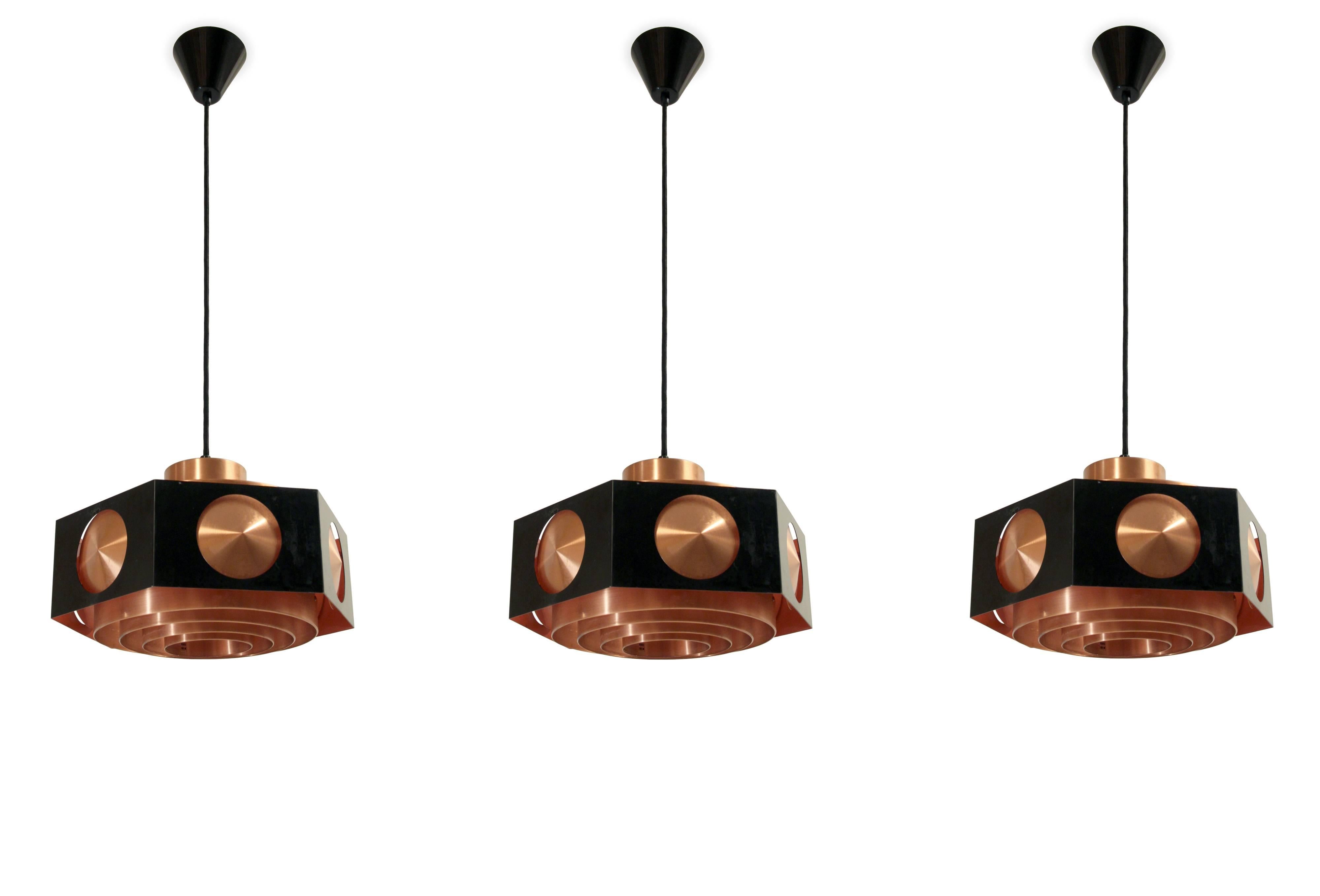 Wonderful and rare set of three ceiling pendants in copper and painted steel. Designed and made in Norway by T. Røstad & Co. from circa 1960s second half. The lamps are fully working and in very good vintage condition. Each lamp holds one E27 bulb