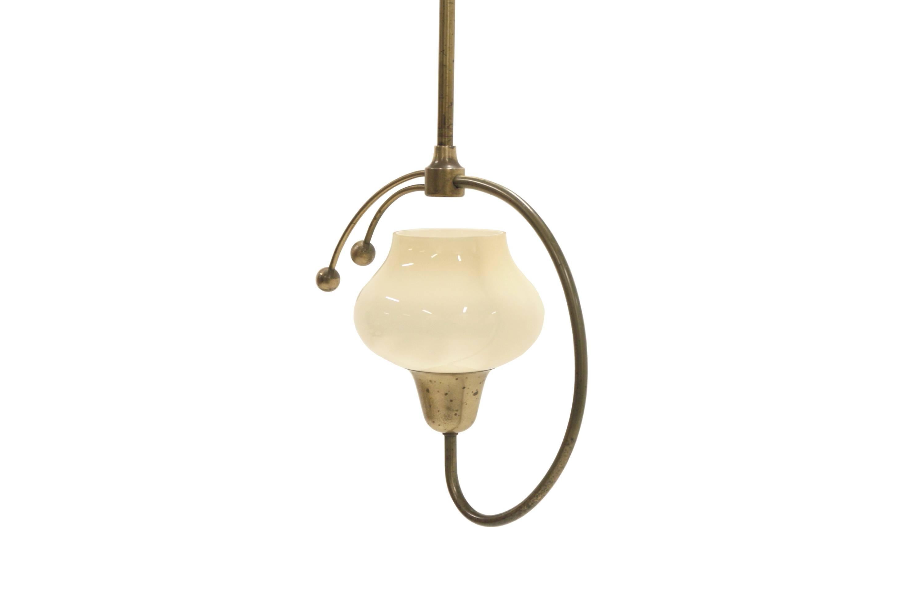 Sculptural and decorative ceiling light on a brass frame with shade in opaline glass. Most likely designed and made in Denmark by Fog & Mørup, circa 1930s first half. The lamp is fully working and in very good vintage condition.
    