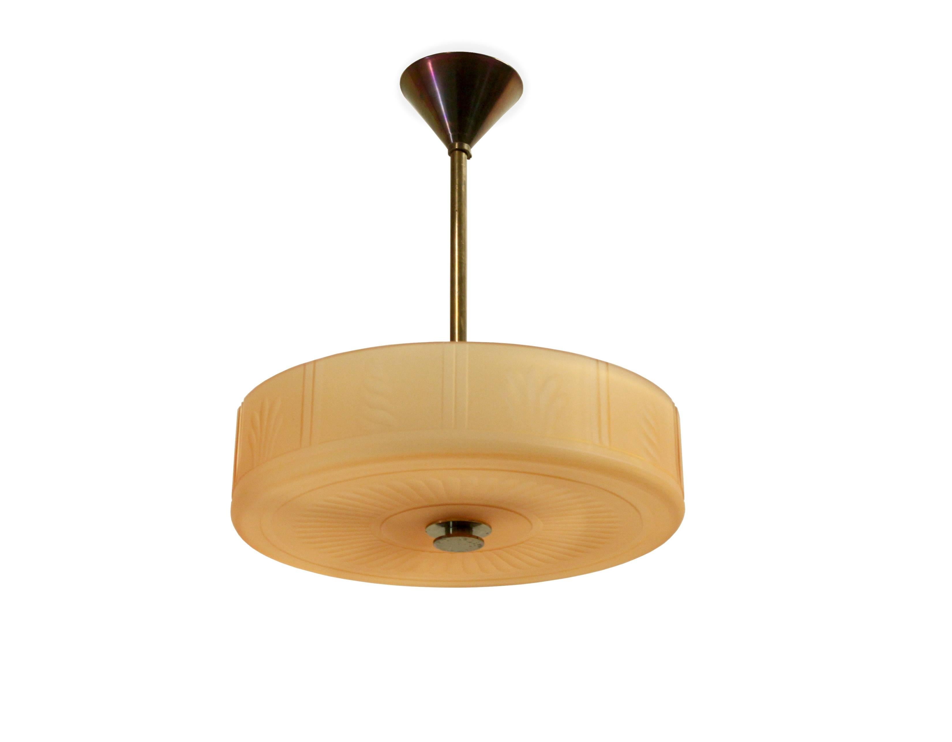 Wonderful and decorative ceiling lamp in Havana glass and brass stem. Designed and made in Sweden by Orrefors from circa 1930s second half. The lamp is fully working and in excellent vintage condition.