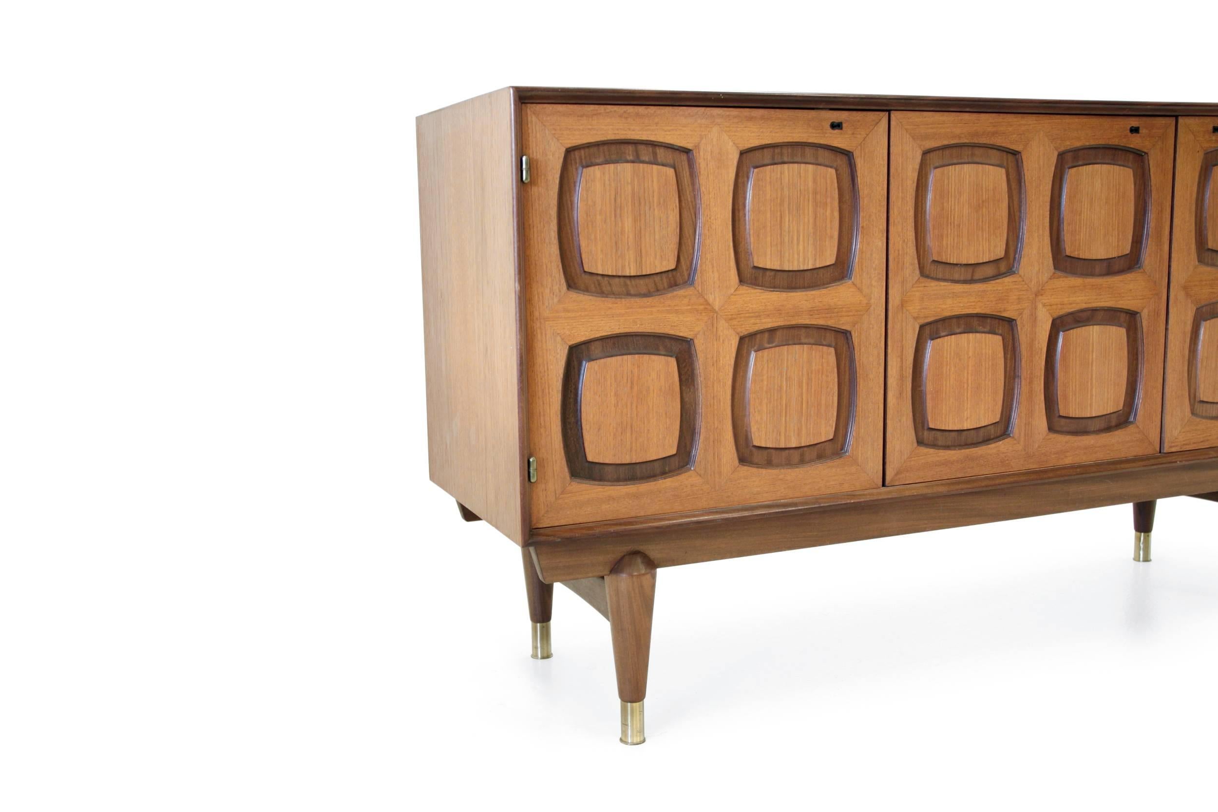 Beautiful and well made sideboard on a teak frame, brass detailing and four drawers.

Model 'Flor'. Designed by Rastad & Relling the leading mid century design studio in norway in the 50'60s. Made by Gustav Bahus Eftf.

In excellent vintage