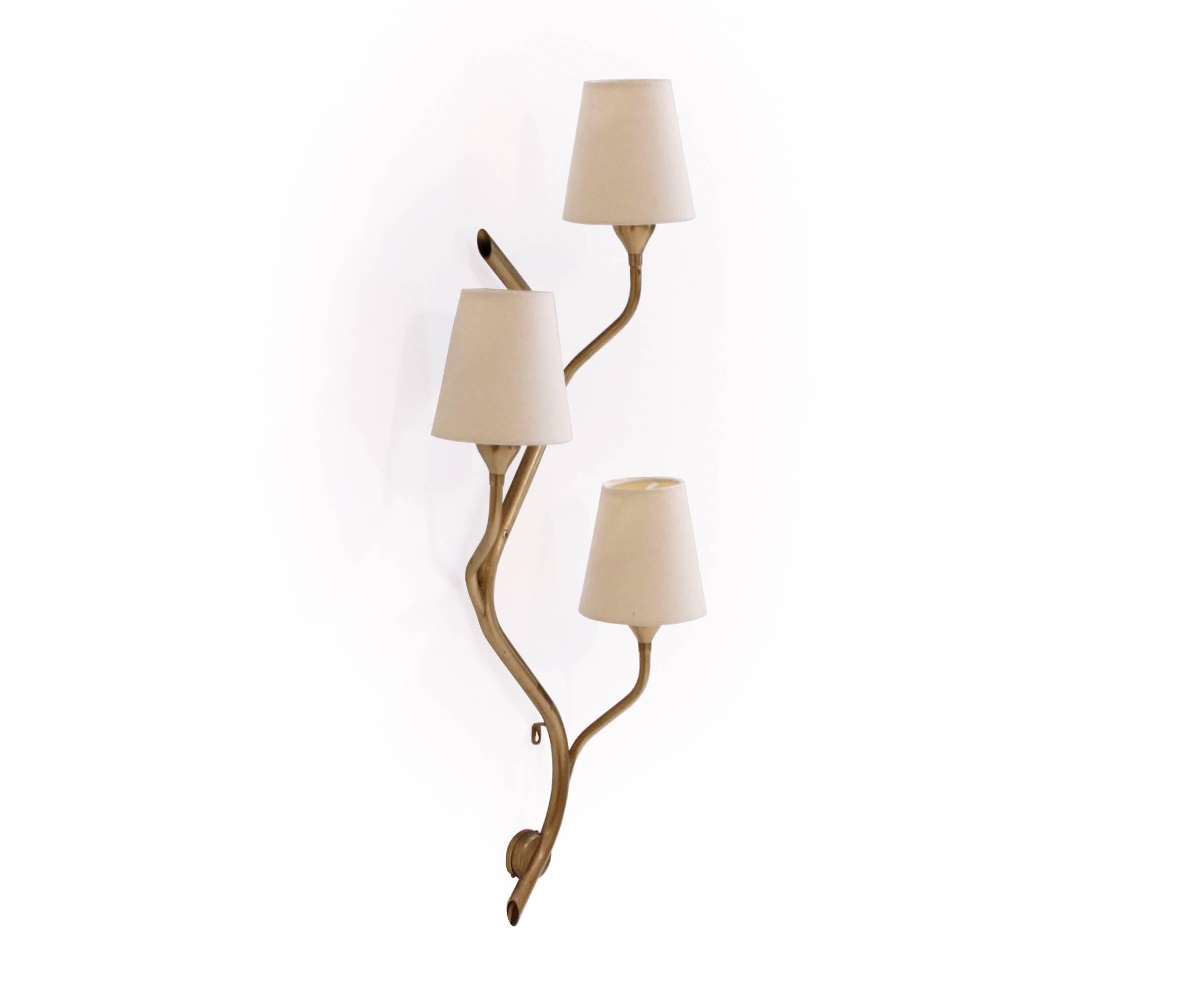 Three-armed wall lamp in brass frame and shades in fibre designed and made in Norway by Astra from circa 1960s second half. The lamp is fully working and in excellent vintage condition with some minor surface marks.

 