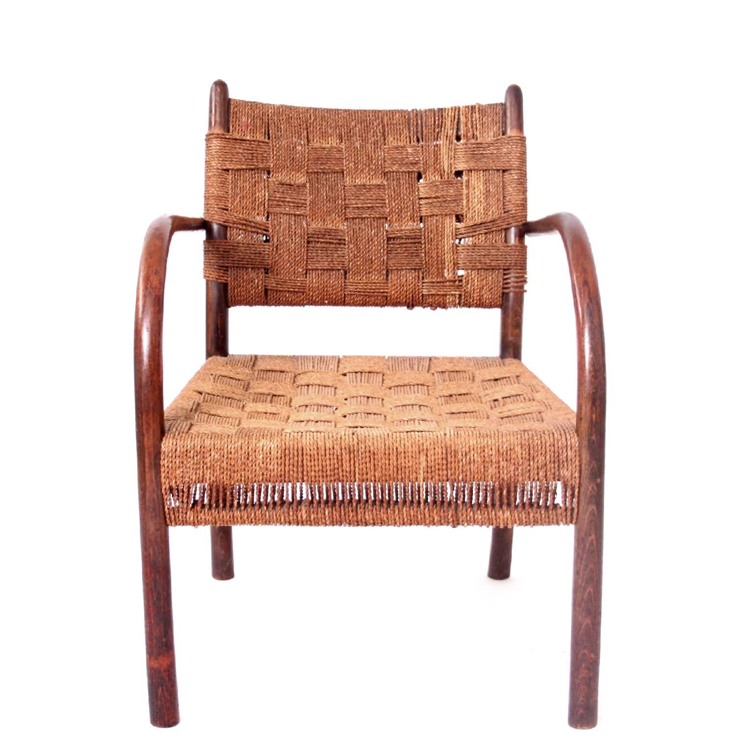 Armchair designed by Frits Schlegel, stained beech frame, seat and back upholstered with original woven sea grass. 

Manufactured by Fritz Hansen, Denmark, 1930s. 

Fine original vintage condition.