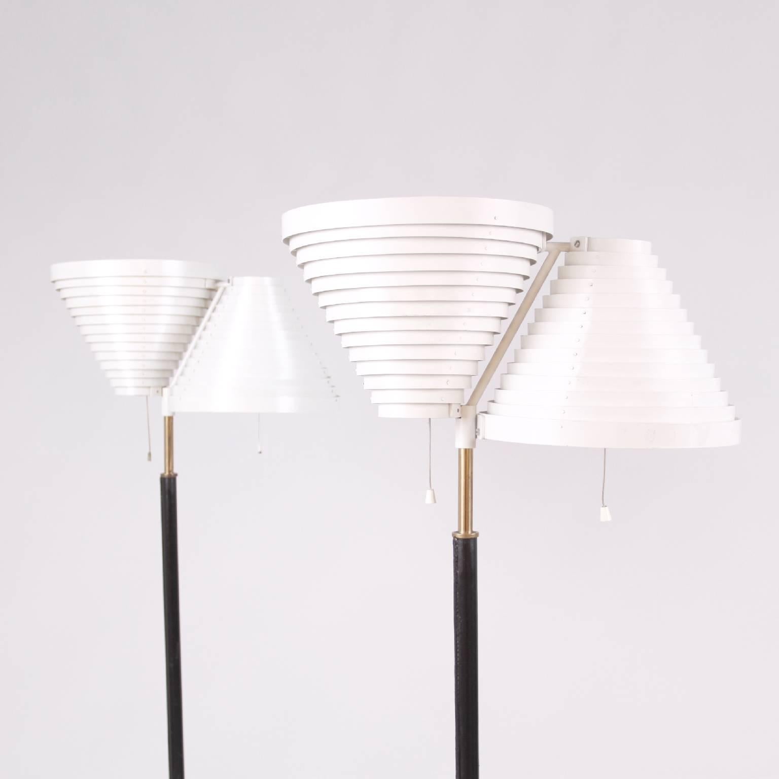 A rare pair of Alvar Aalto floor lamps model A810.
Manufactured by Valaistustyö Ky, Finland, 1950s.
Top of stem impressed with Valaistustyo/A 810 (First production).
Painted metal, brass, tubular brass, leather bound tubular metal, bound metal.