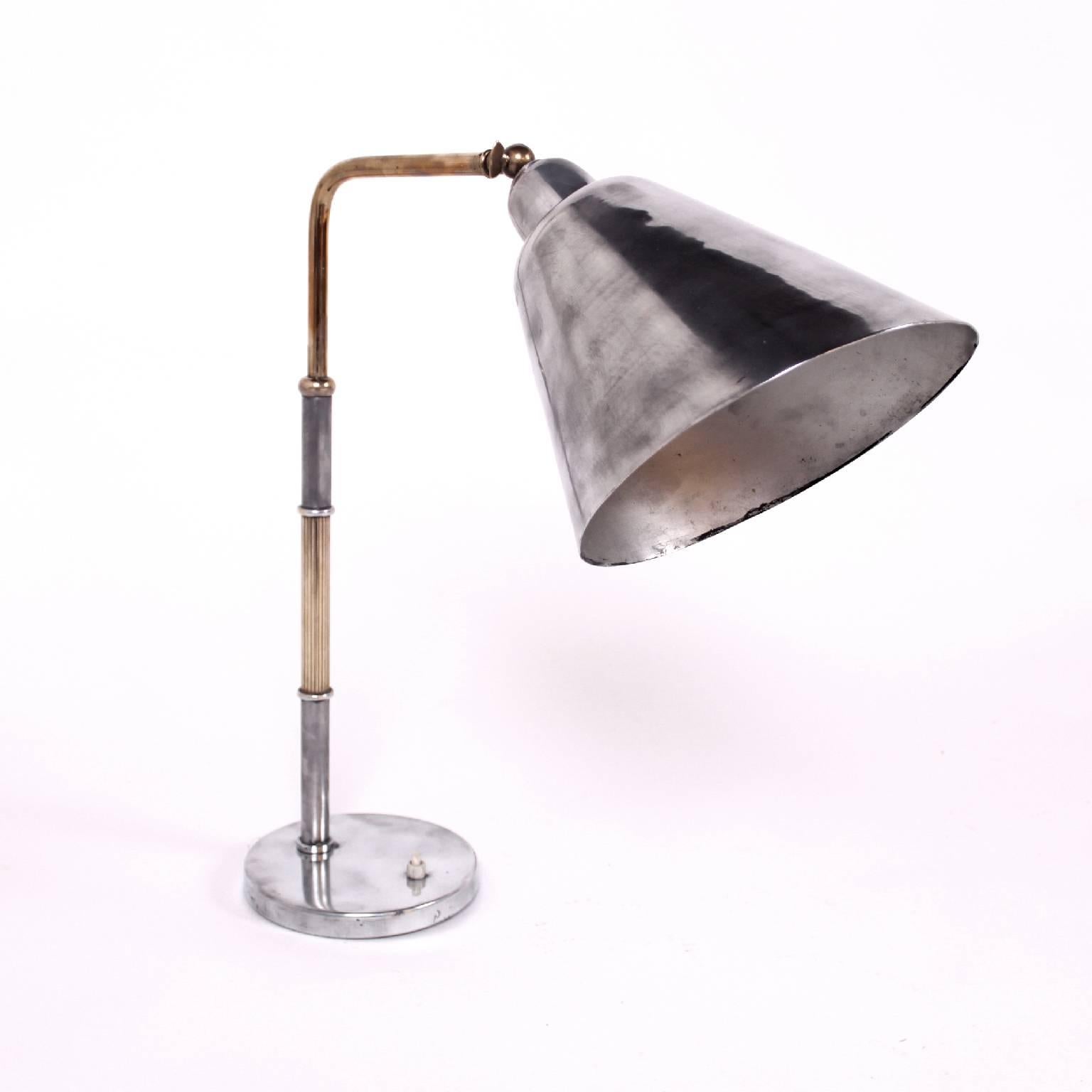Table lamp with adjustable shade.
Materials: Brass and polished aluminium.
 